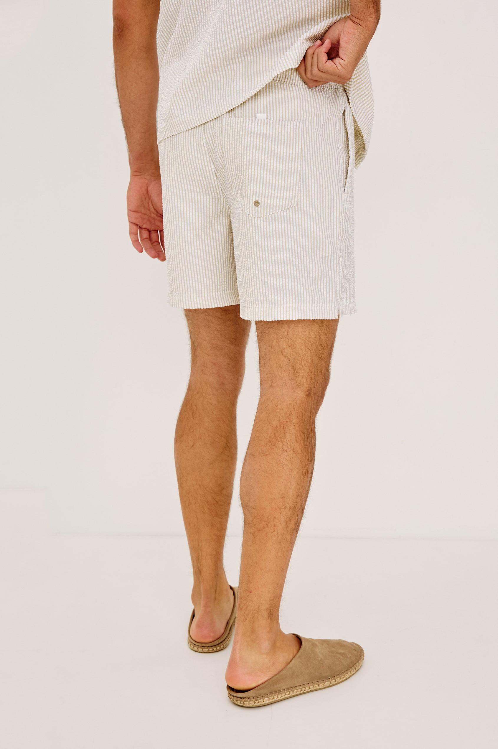 La Brea Mid-Length Swim Shorts With Adjustable Waist Drawstring Ties and Side Pockets in Khaki White Seersucker Colorway - Lower Body Back View Featured on Model