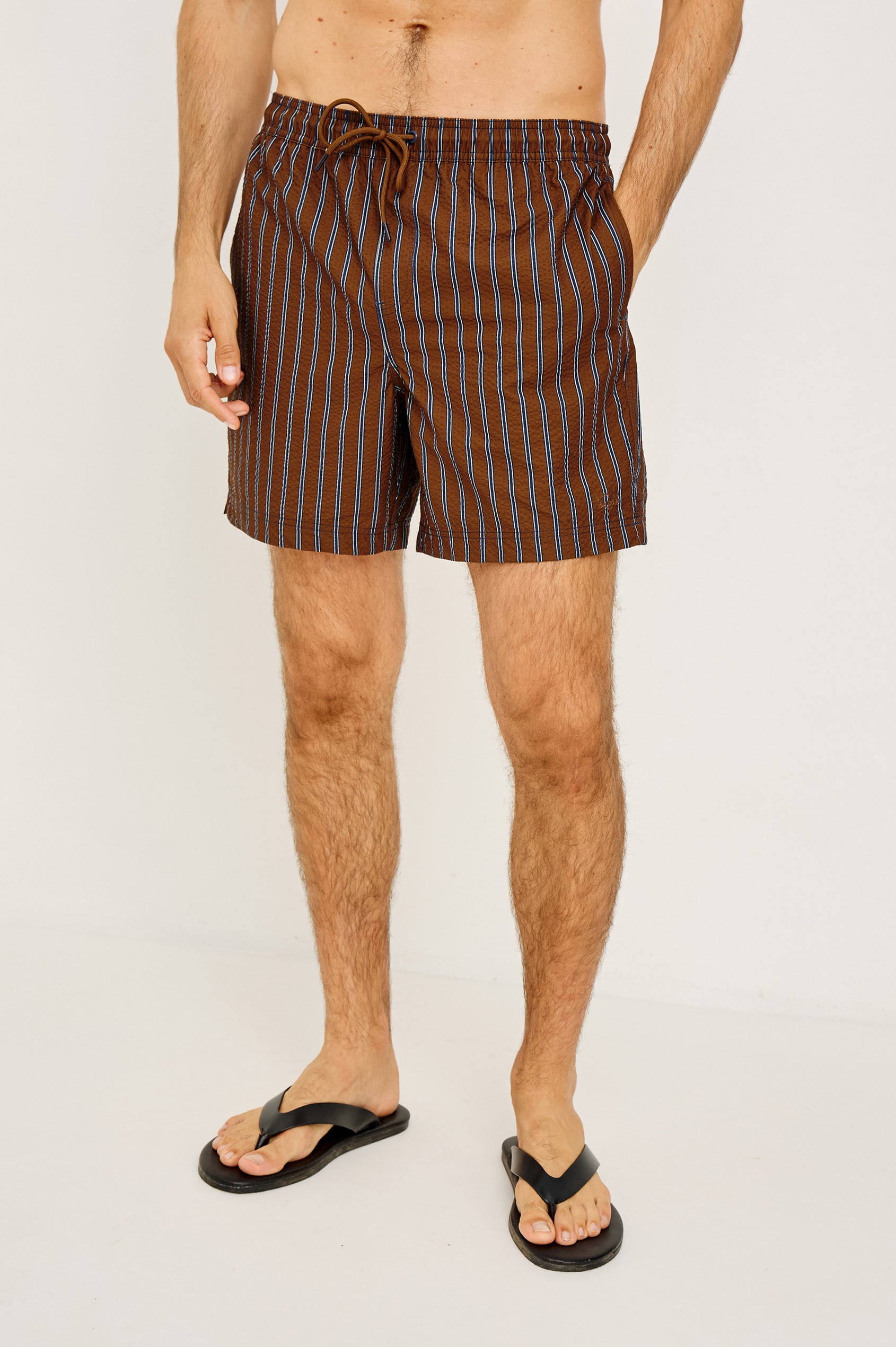 La Brea Mid-Length Swim Shorts With Adjustable Waist Drawstring Ties and Side Pockets in Rust Navy Stripe Colorway - Lower Body Front View Featured on Model
