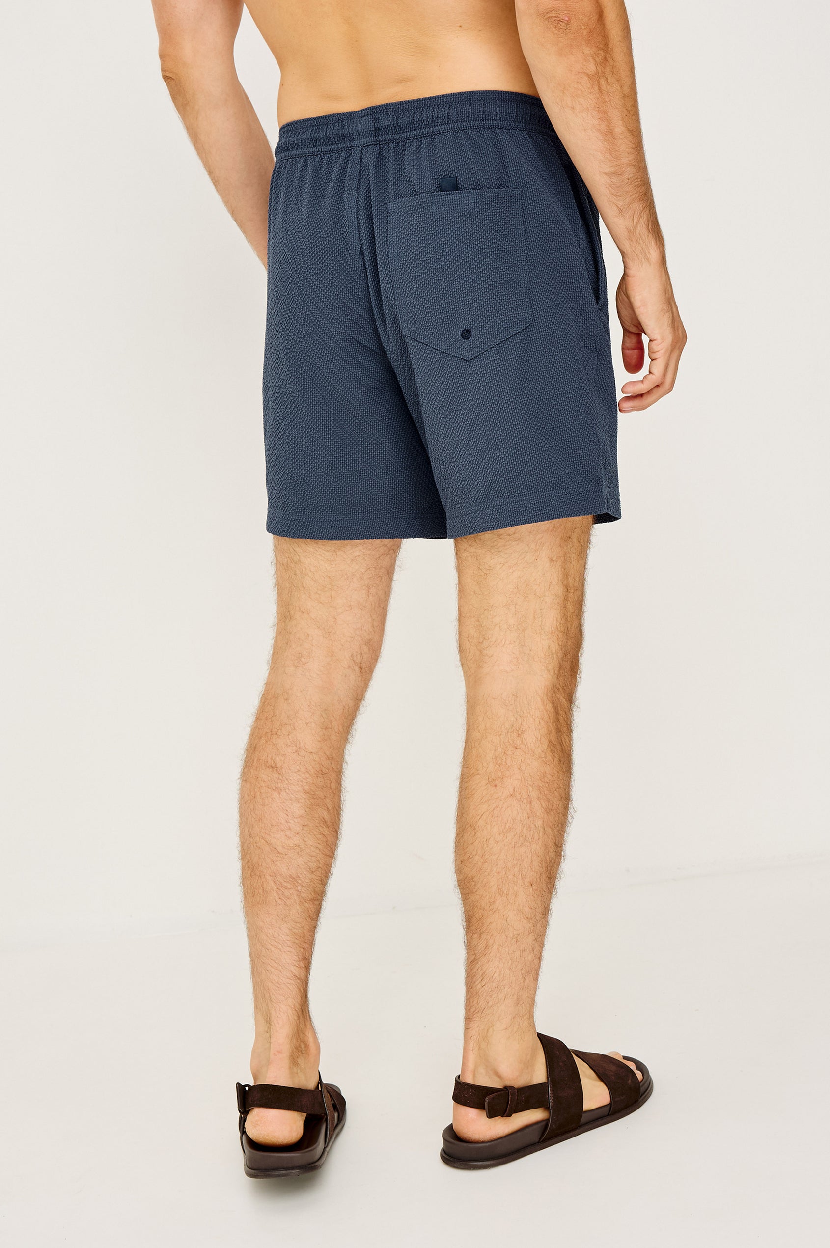 La Brea Swim Short in Stretch Polyester Seersucker With Adjustable Drawstring Waist Ties in Stratos Colorway - Lower Body Back View Featured on Model