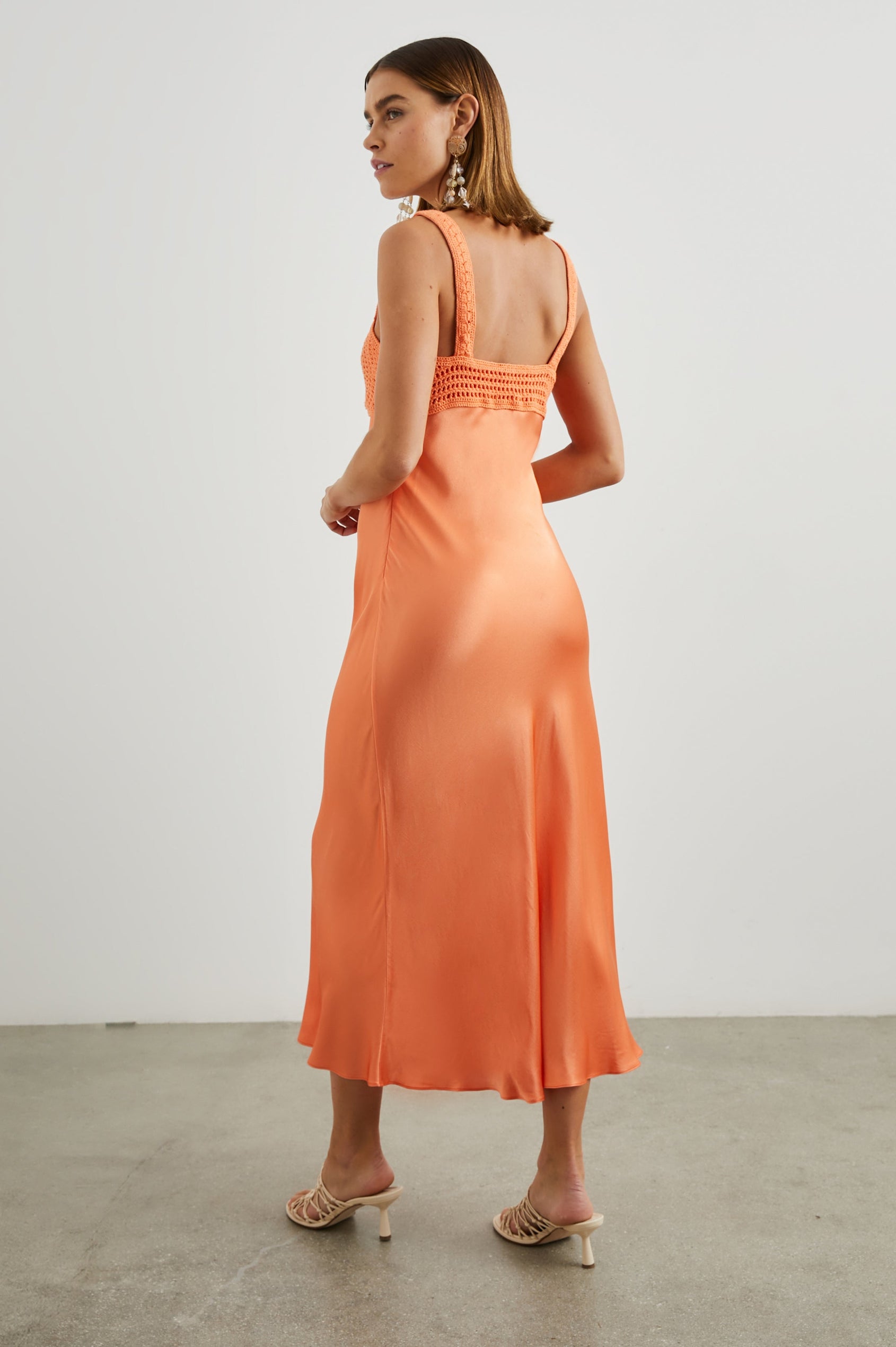 Laura Sleeveless Midi Dress with a Sweetheart Neckline and Crochet on the Bodice and Shoulder Straps in Papaya Colorway - Back Full Body View Featured on Model 