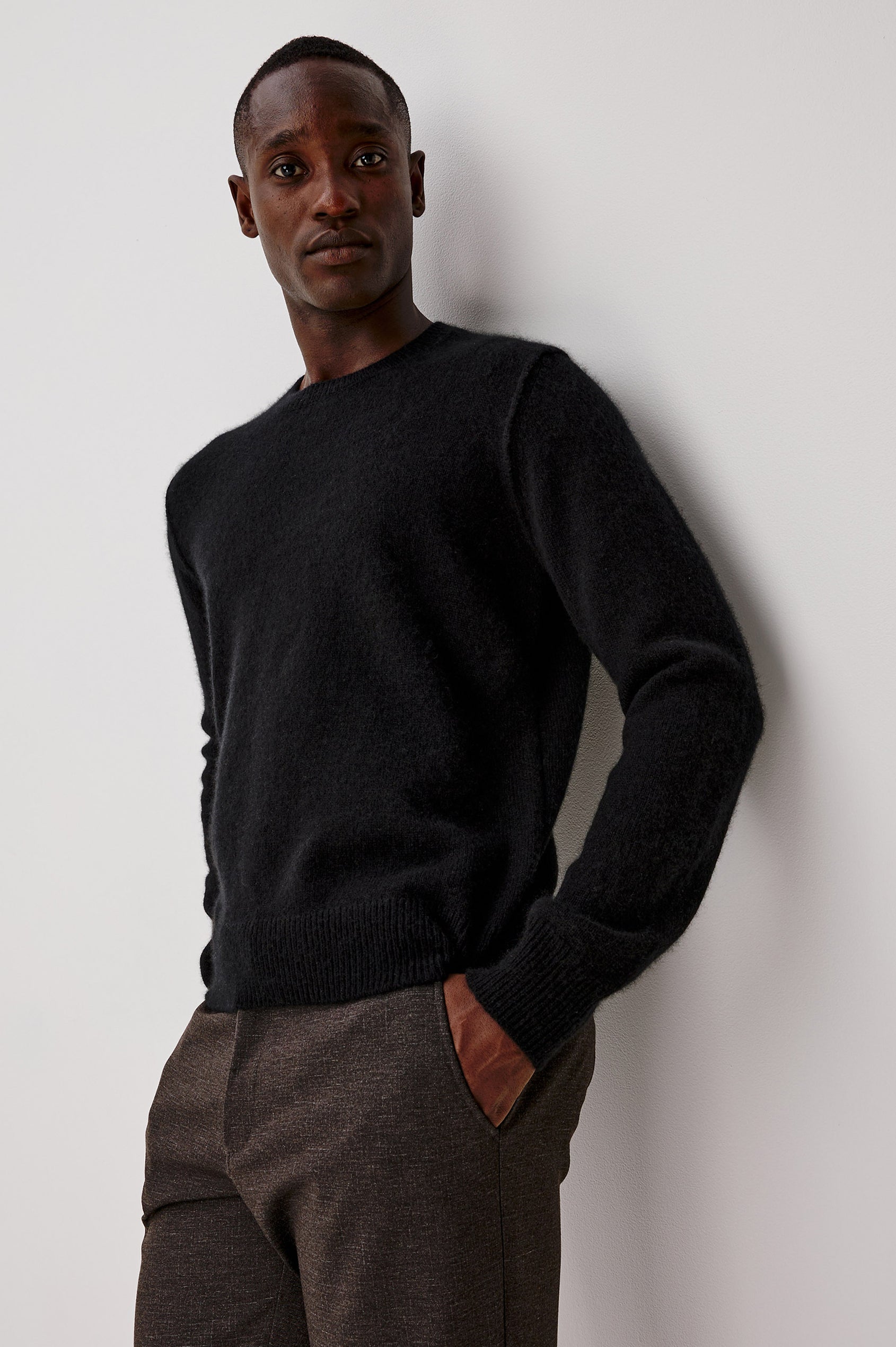 Laurent Sweater in Merino Wool Cashmere Blend With Relaxed Fit, Reversed Linking Seams at Arm Holes, and Long Sleeves in Black Colorway - Upper Body Front View Featured on Model