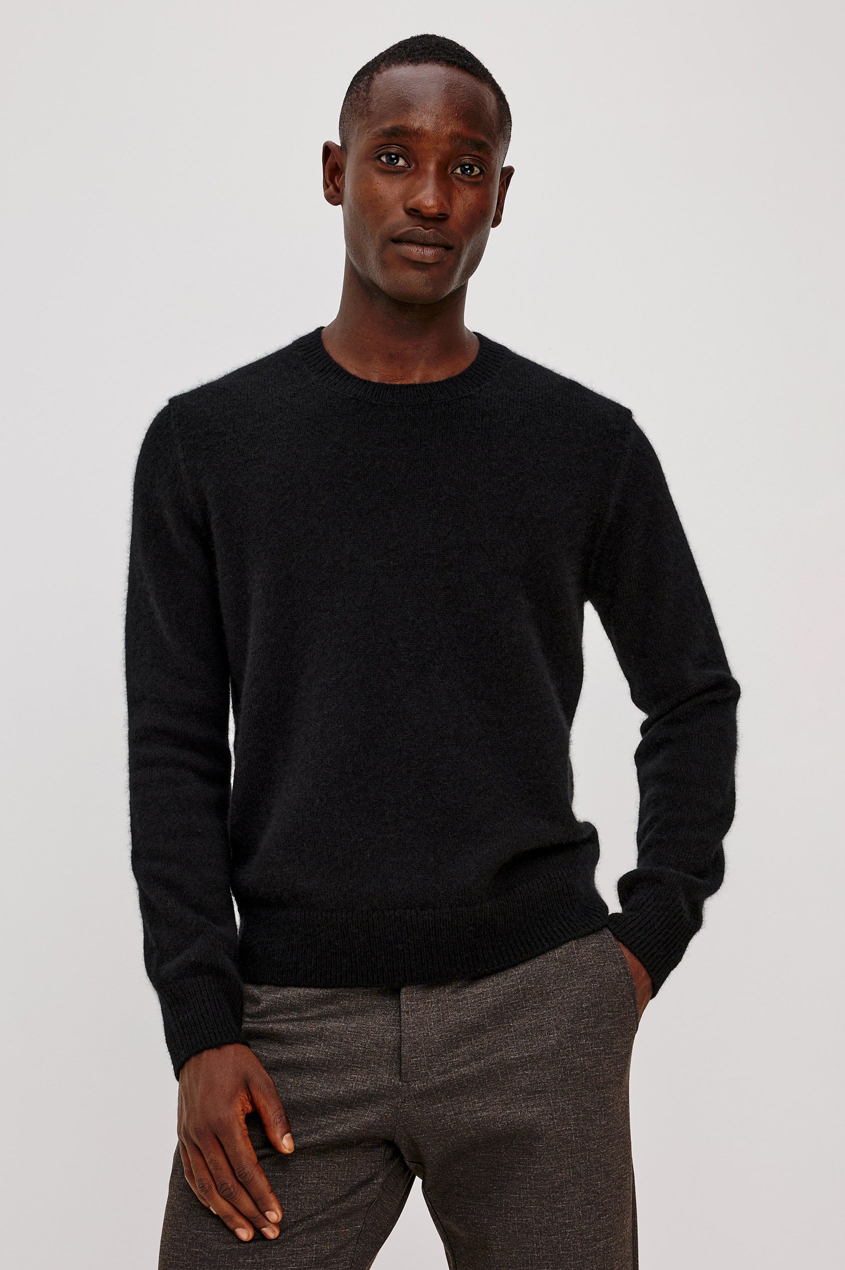 Laurent Sweater in Merino Wool Cashmere Blend With Relaxed Fit, Reversed Linking Seams at Arm Holes, and Long Sleeves in Black Colorway - Upper Body Front View Featured on Model