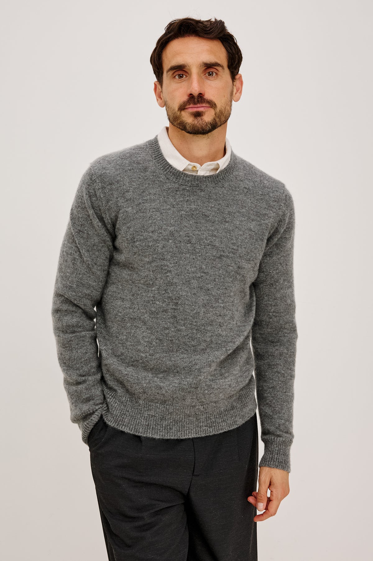 Laurent Sweater in Wool Blend With Crewneck, Dropped Shoulders, Linked Stitch Detailing, and Long Sleeves in Charcoal Colorway - Upper Body Front View Featured on Model