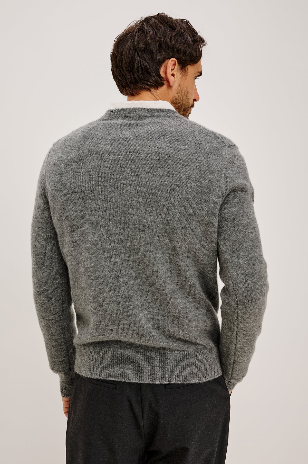 Laurent Sweater in Wool Blend With Crewneck, Dropped Shoulders, Linked Stitch Detailing, and Long Sleeves in Charcoal Colorway - Upper Body Back View Featured on Model