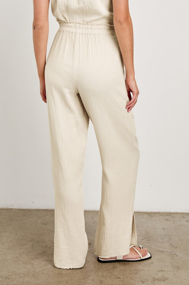 Leon Cotton Gauze Pant With Hemline Slit And Elastic Waist In Colorway Flax -  Back View Featured On Model