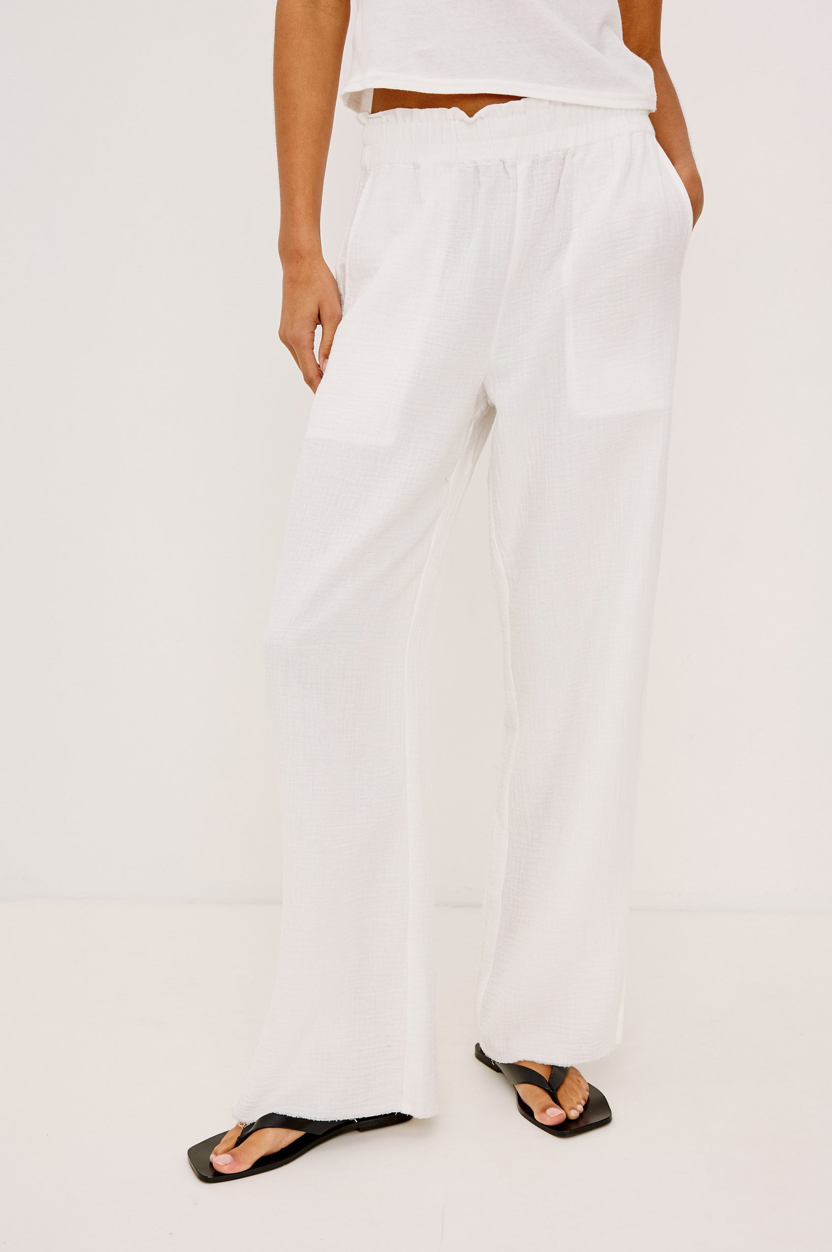 Leon Crop Pant in Double Gauze Cotton With Wide Straight Legs, Side Slits, and Smocked Waistband in White Colorway - Lower Body Front View Featured on Model