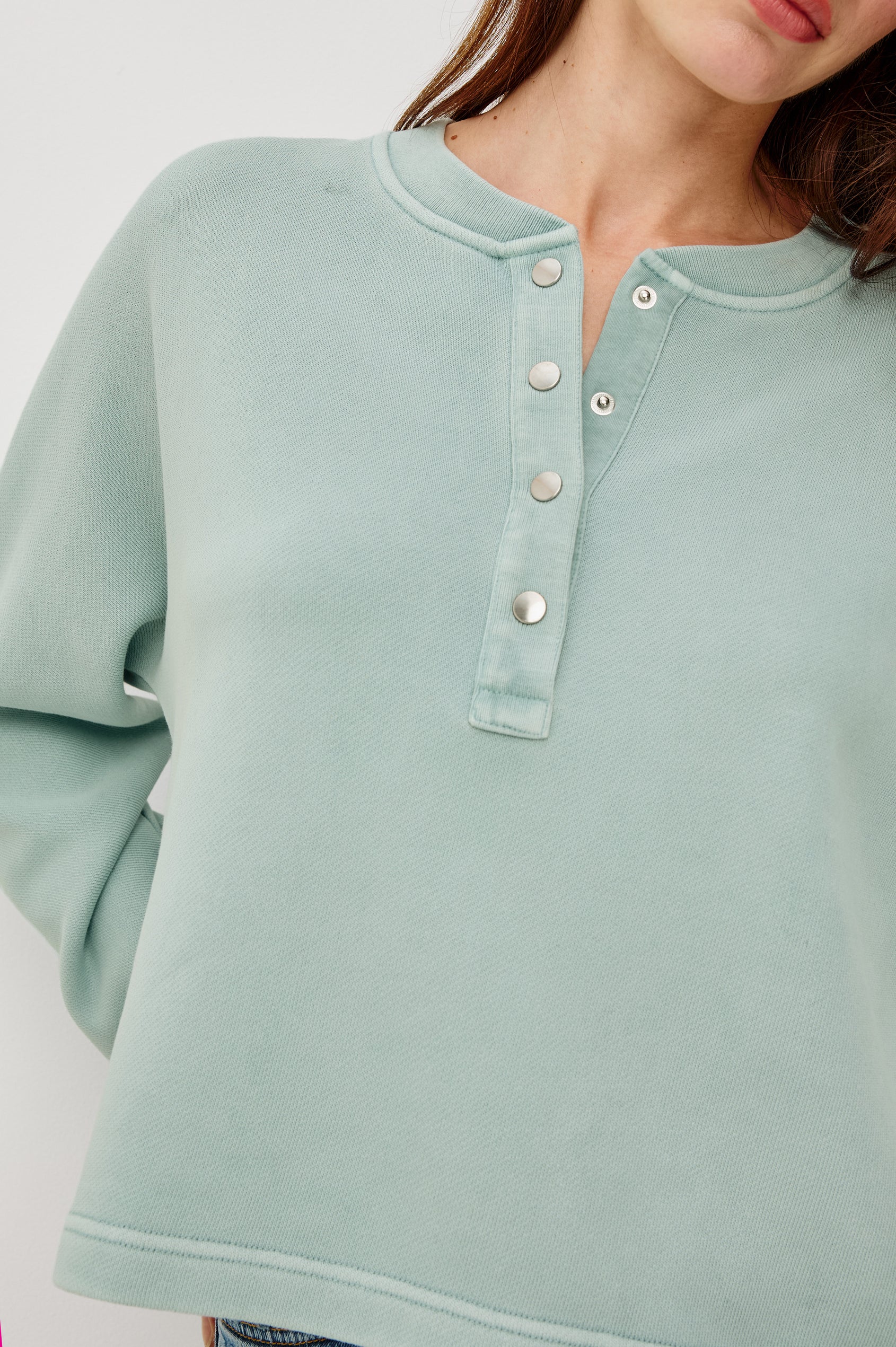 Leonie Sweatshirt in French Terry With Relaxed Boxt Fit, Snap Button Half Placket, Long Puff Sleeves, and Ribbed Neckline and Cuffs in After Midnight Colorway - Upper Body Front Close Up View Featured on Model