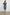 Letta Above-Knee Dress with Flutter Sleeves, Snaps down the Front, and a Belted Waist in Classic Blue Colorway - Back Full Body View Featured on Model 