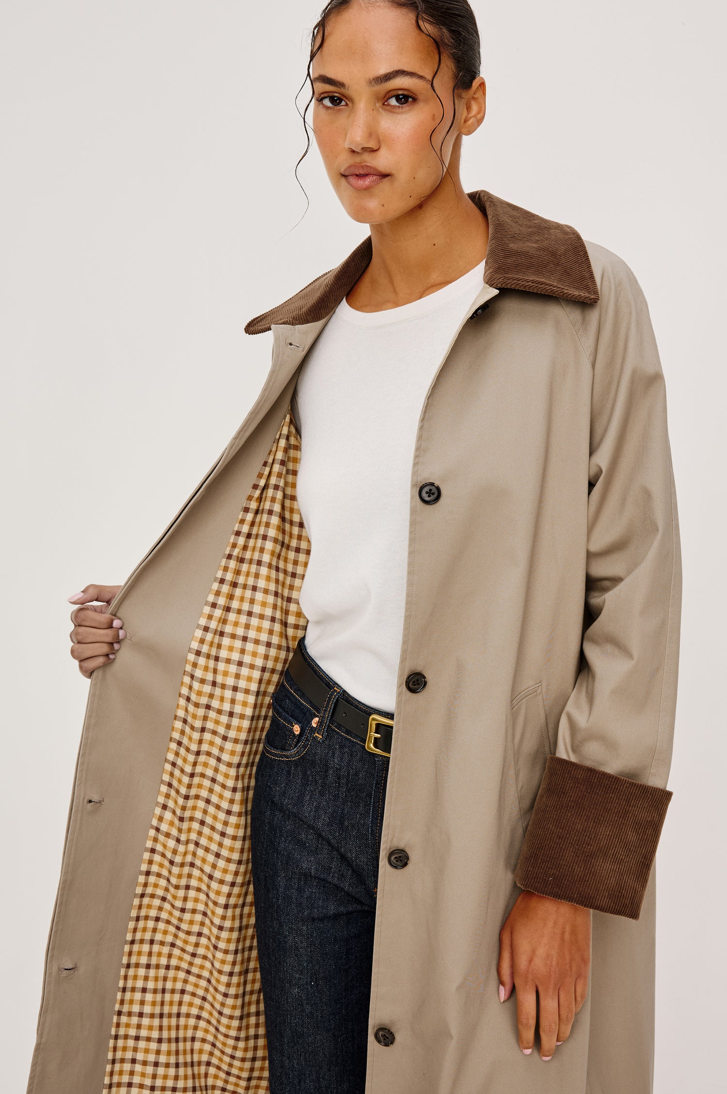 Full-length coat with a classic silhouette in Raisin Colorway. The coat is fully lined in plaid and finished with corduroy accents at the cuffs and collar for a heritage-inspired look. Front Crop View featured on Model.