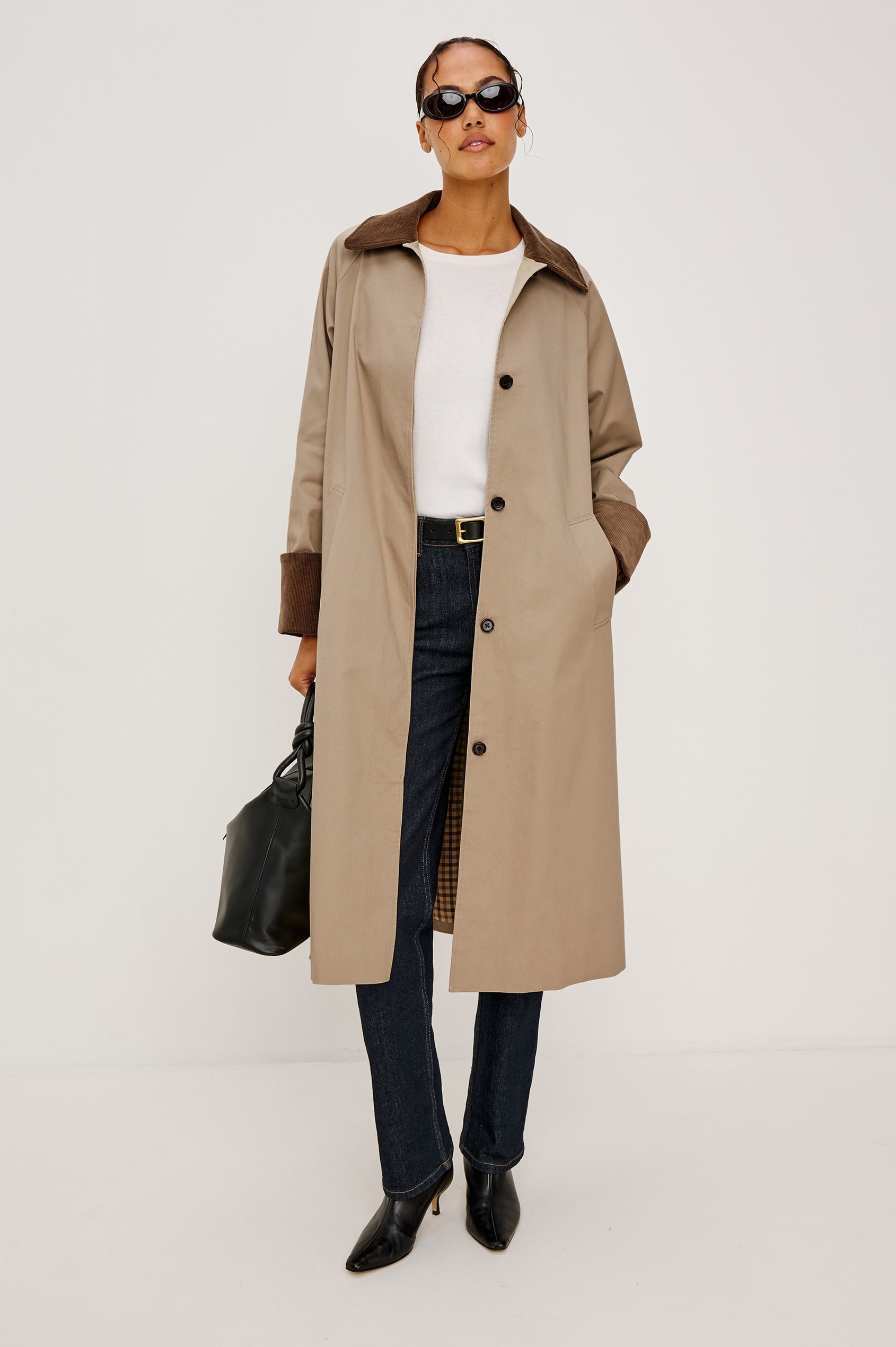 Full-length coat with a classic silhouette in Raisin Colorway. The coat is fully lined in plaid and finished with corduroy accents at the cuffs and collar for a heritage-inspired look. Front View featured on Model.