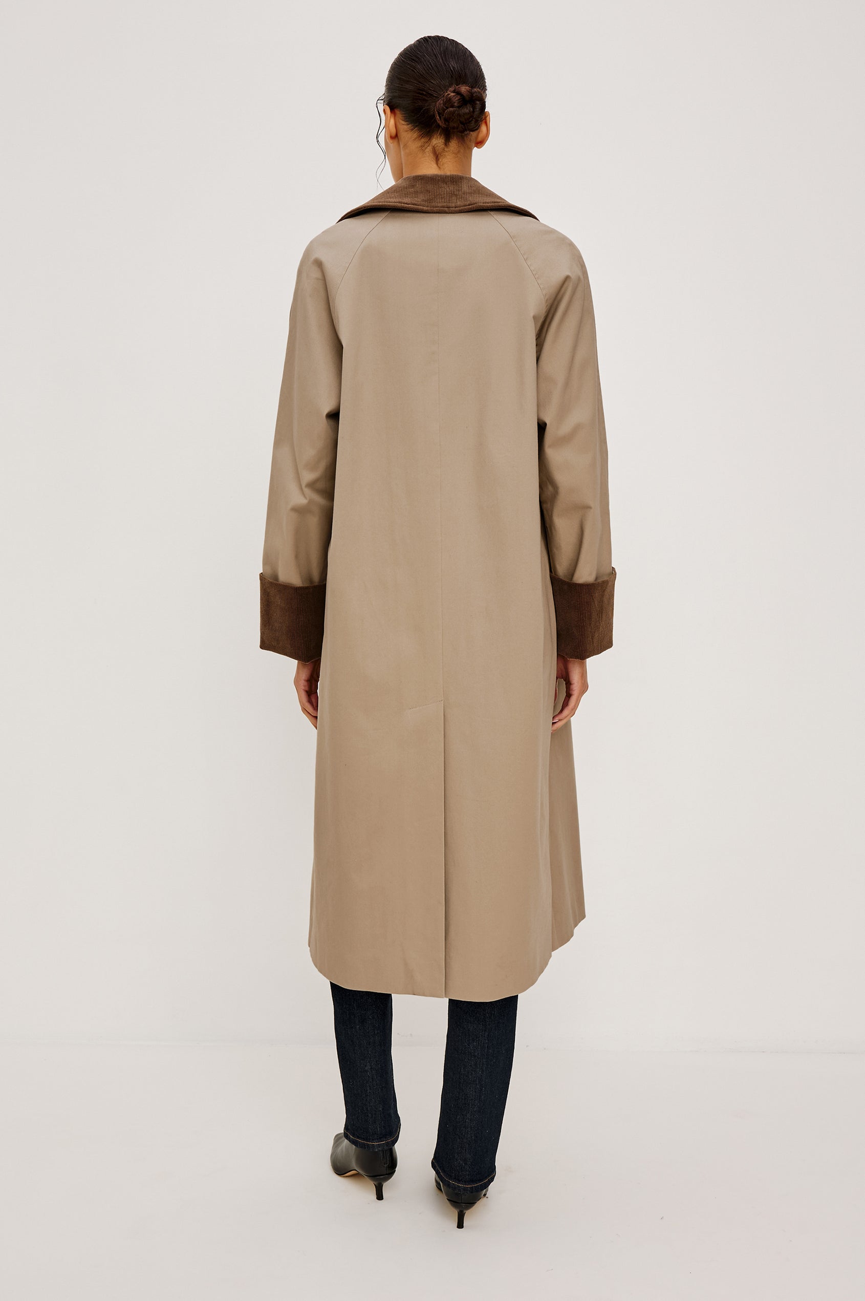 Full-length coat with a classic silhouette in Raisin Colorway. The coat is fully lined in plaid and finished with corduroy accents at the cuffs and collar for a heritage-inspired look. Back View featured on Model.