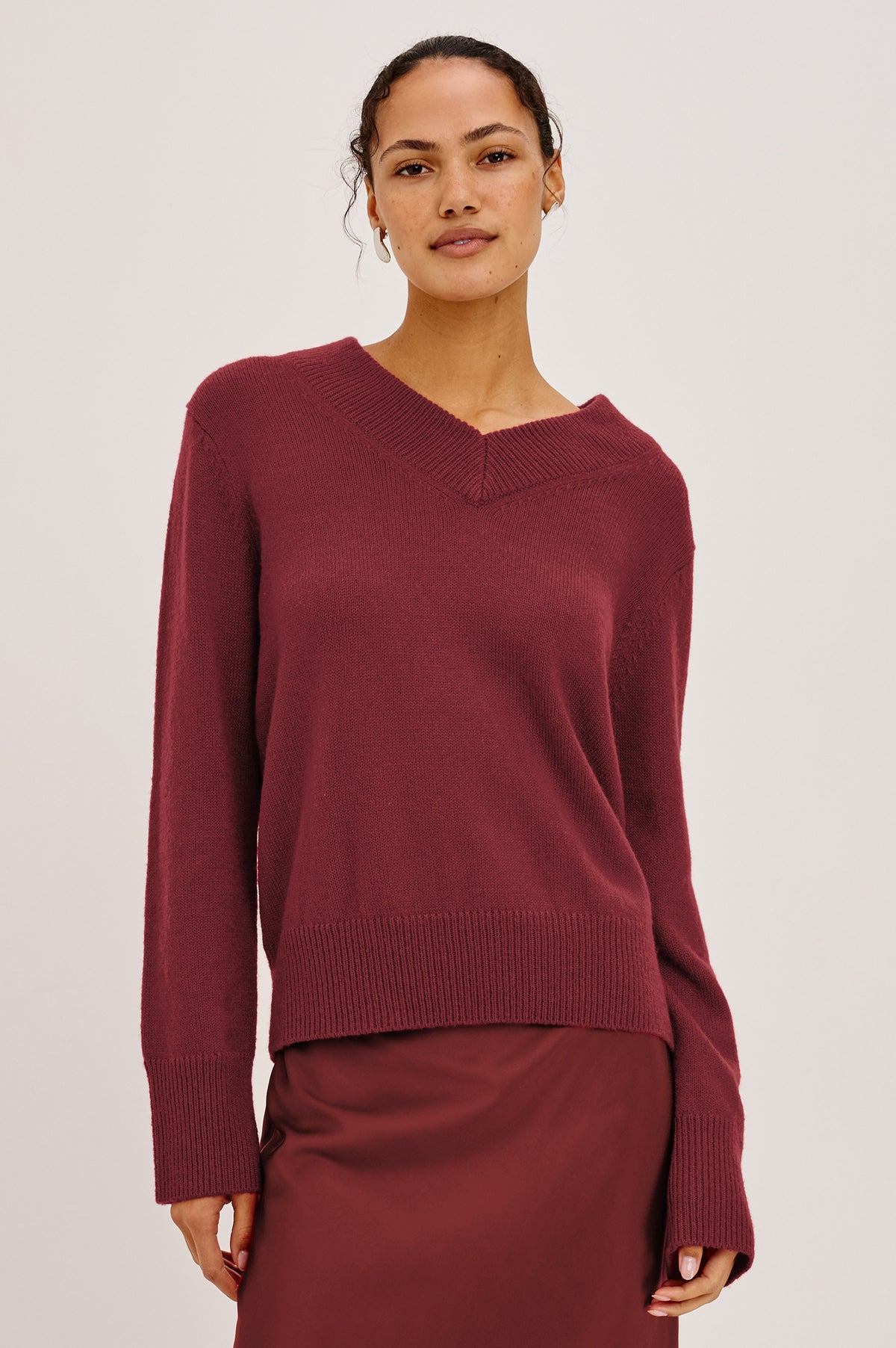 Lidya Sweater in Wool-Cashmere Knit Blend With V-Neckline, Loose Relaxed Fit, Long Sleeves, and Ribbed Trim in Crimson Colorway - Upper Body Front View Featured on Model
