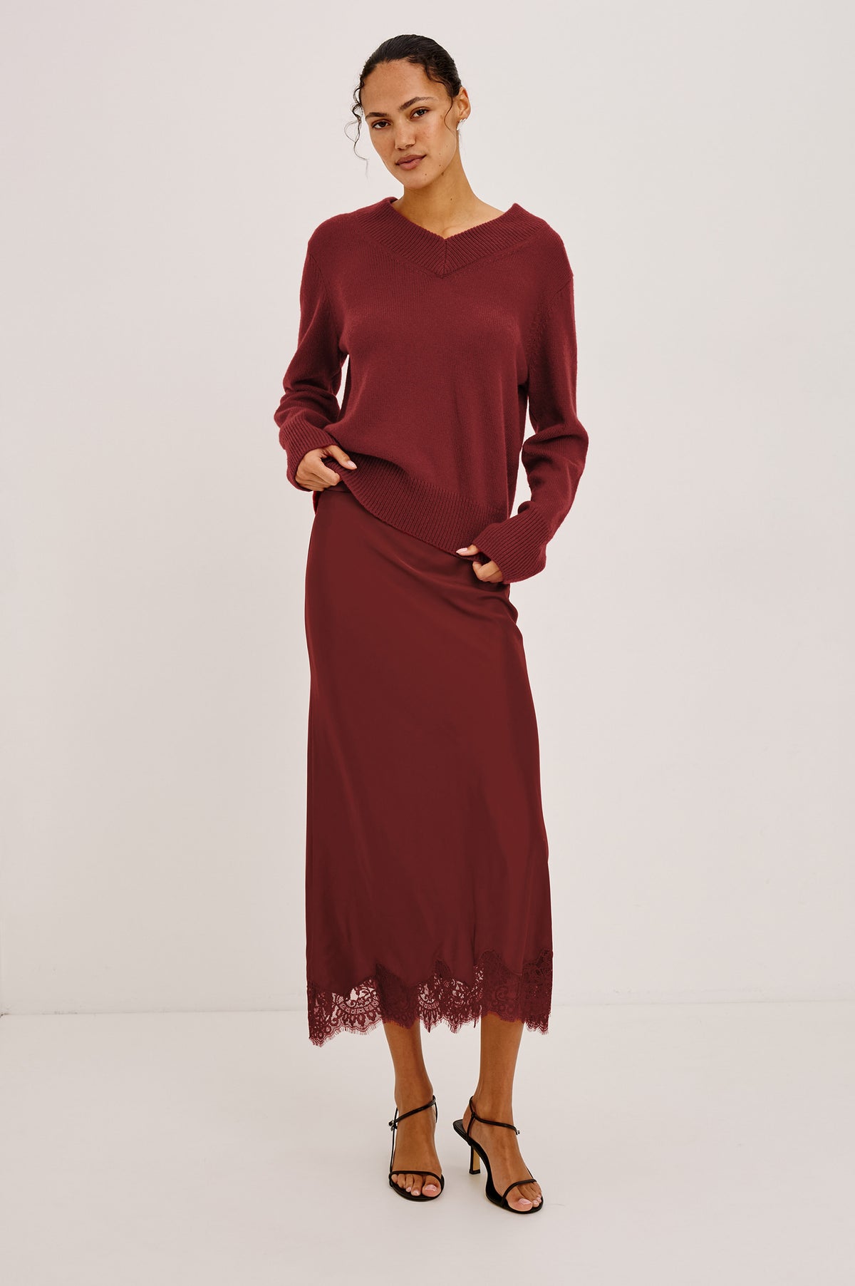 Lidya Sweater in Wool-Cashmere Knit Blend With V-Neckline, Loose Relaxed Fit, Long Sleeves, and Ribbed Trim in Crimson Colorway - Full Body Front View Featured on Model