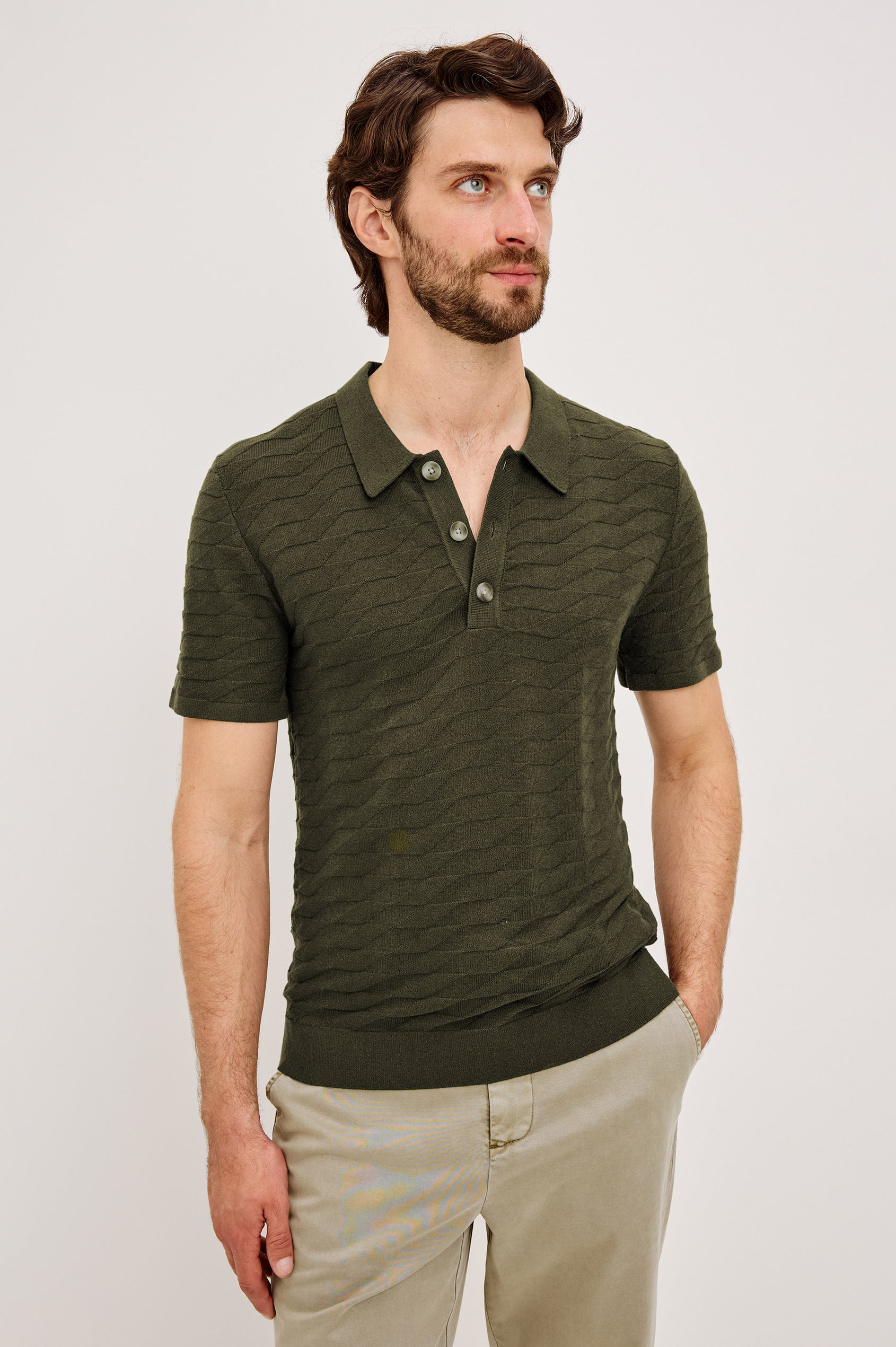 Linden Polo Shirt in Cotton Knit With Subtle Diamond Texture, Classic Fit, Quarter Button Placket, Short Sleeves, and Ribbed Trim in Ancient Olive Prism Colorway - Upper Body Front View Featured on Model