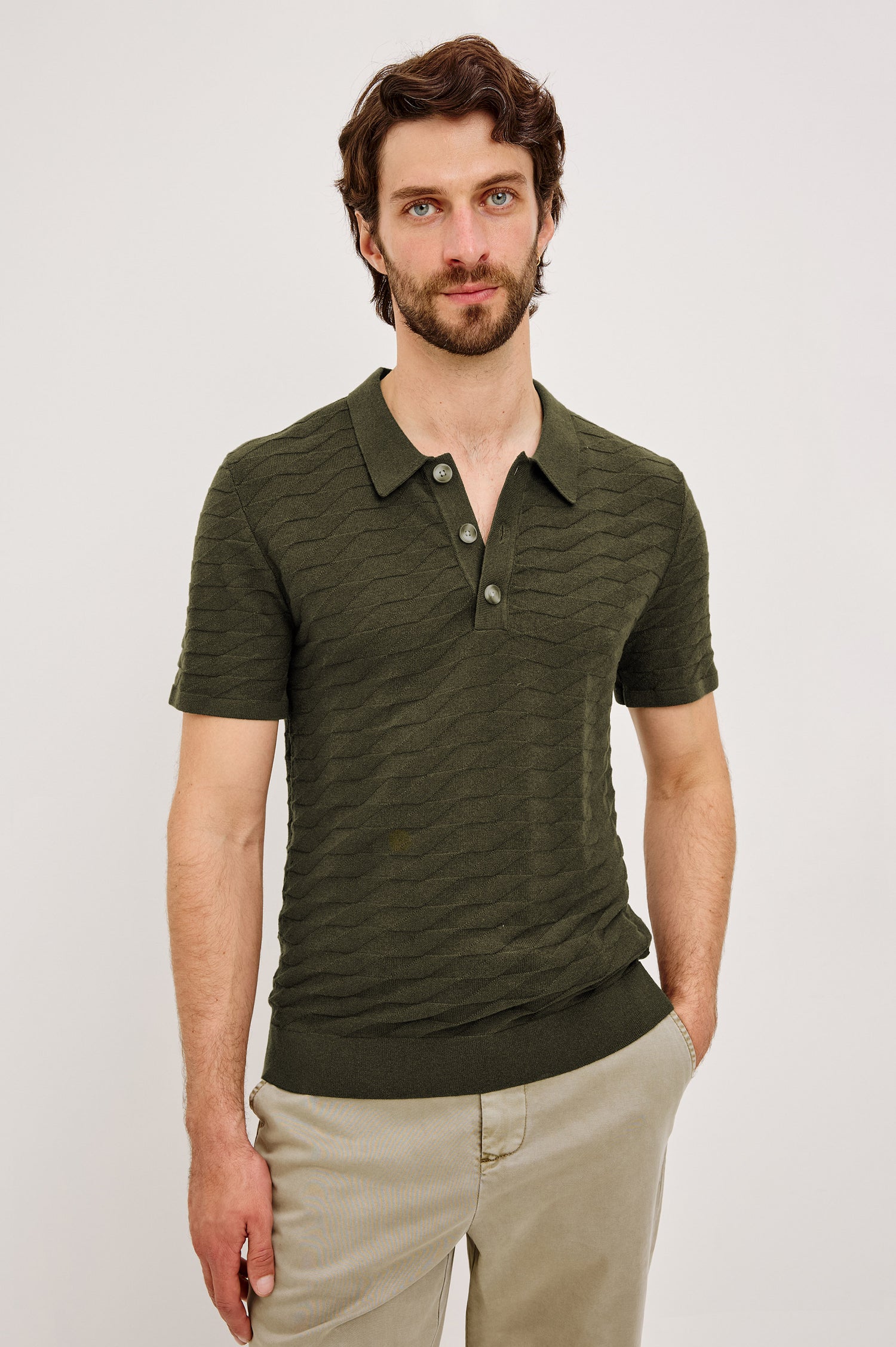 Linden Polo Shirt in Cotton Knit With Subtle Diamond Texture, Classic Fit, Quarter Button Placket, Short Sleeves, and Ribbed Trim in Ancient Olive Prism Colorway - Upper Body Front View Featured on Model