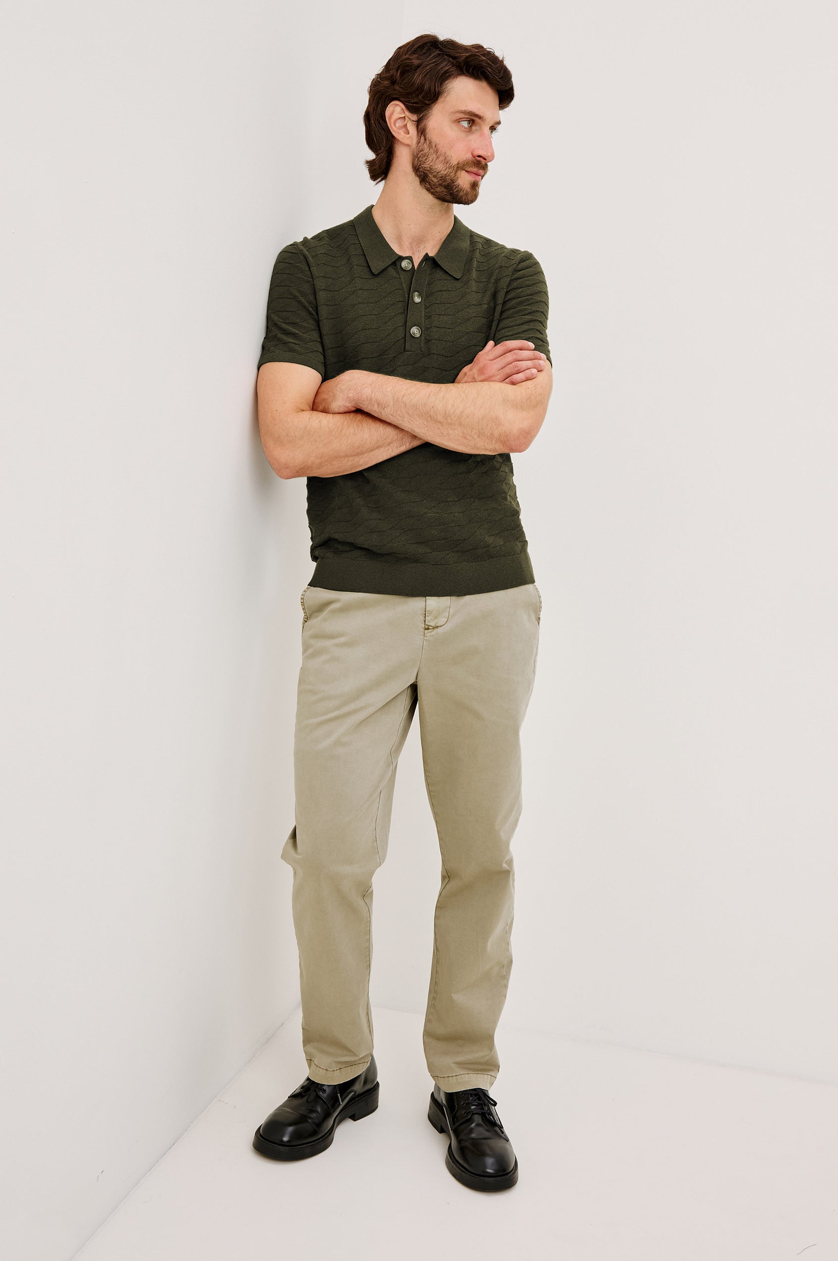Linden Polo Shirt in Cotton Knit With Subtle Diamond Texture, Classic Fit, Quarter Button Placket, Short Sleeves, and Ribbed Trim in Ancient Olive Prism Colorway - Full Body Front View Featured on Model