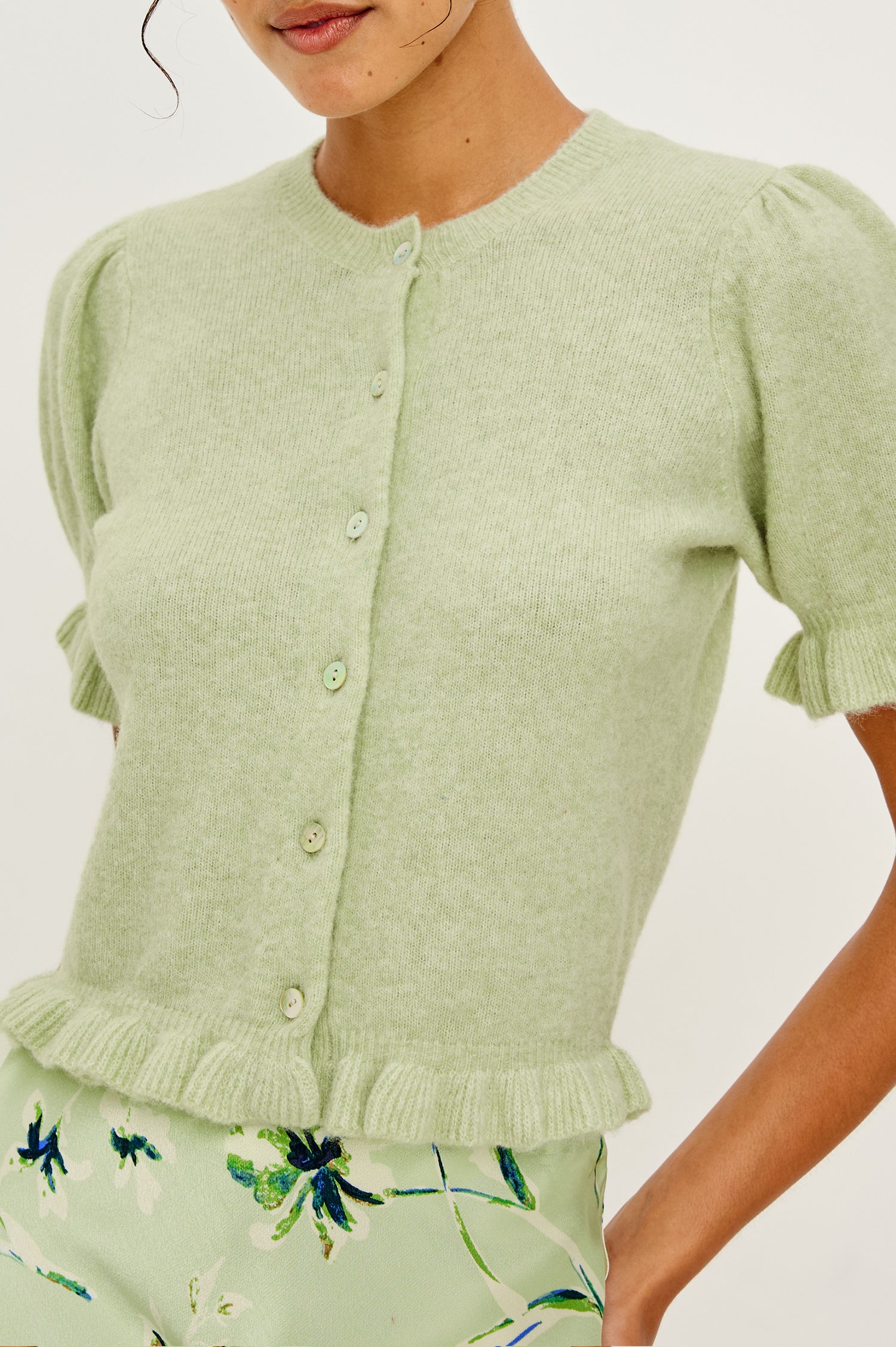 Lora Wool Cardigan With Crewneck Short Puff Sleeves and Hem With Ruffle Trim and Front Buttons in Julep Colorway - Upper Body Front Close Up View Featured on Model