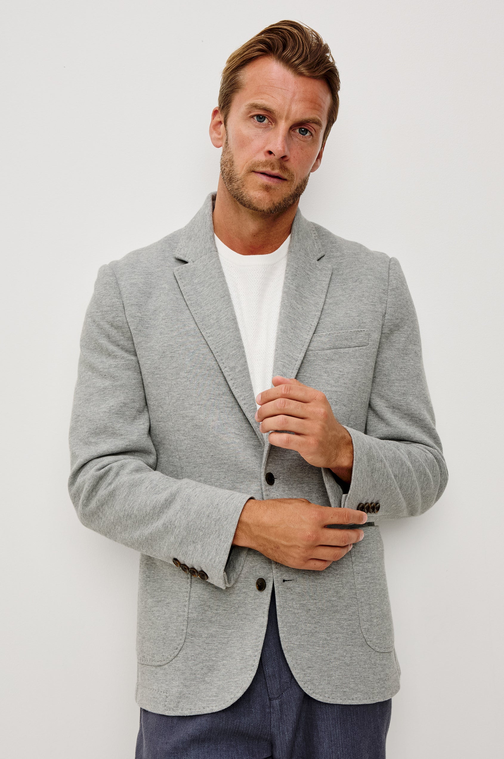 Lorenz Blazer in Cotton Blend With Notched Lapels, Long Sleeves, Front Buttons, Chest Pocket, and SIde Patch Pockets in Heather Grey Colorway - Upper Body Front View Featured on Model