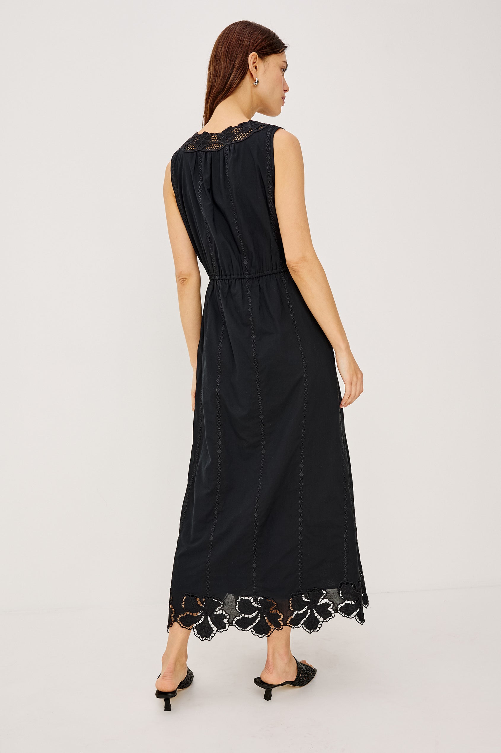 Lorina Midi Dress in Cotton Voile With Lattice and Floral Embroidery, Sleeveless Cut, and Adjustable Waist Ties in Black Colorway - Full Body Back View Featured on Model