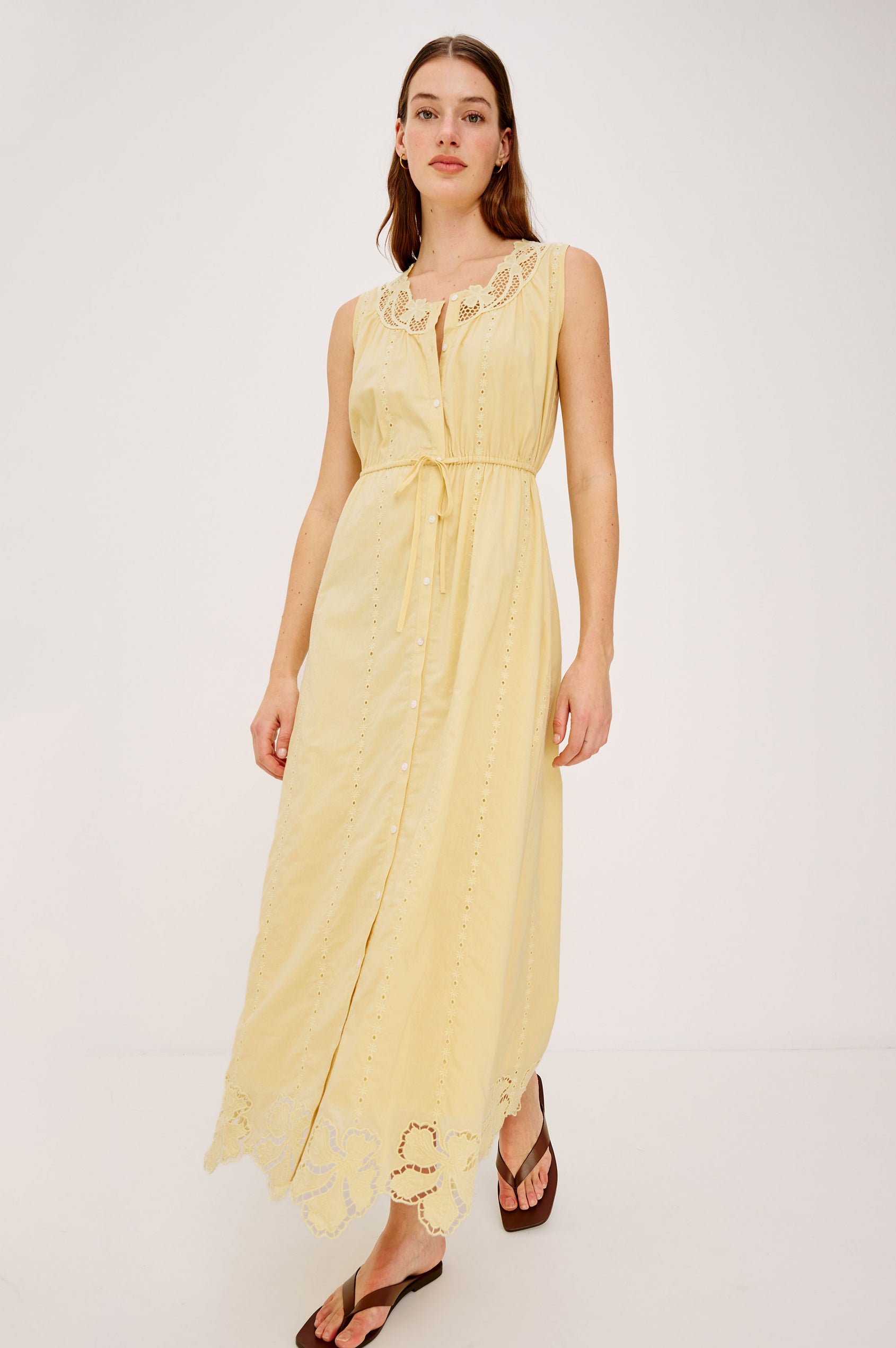 Lorina Midi Dress in Beach Cottton With Lattiice and Floral Embroidery, Sleeveless Cut, and Adjustable Waist Ties in Sunshine Colorway - Full Body Front View Featured on Model