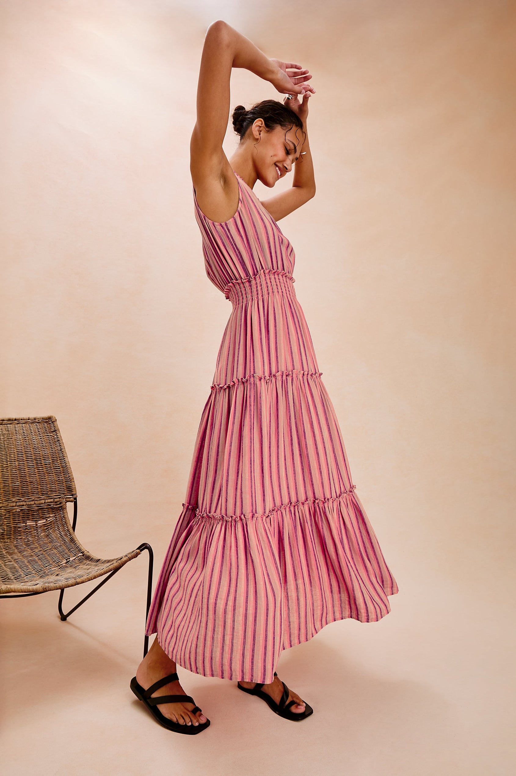 Loulou V-Neck Midi Dress with Smocked Elastic Waistband and a Multi Tiered Skirt in Cabana Stripe Colorway. Full Body Side View Shown on Model.