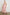 Front view of female model wearing our sleeveless, Loulou Maxi Dress in color Salerno Stripe, a pink and white boho stripe. Dress features smocked waist, v-neck, and tiered maxi skirt. 