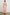 Back view of female model wearing our sleeveless, Loulou Maxi Dress in color Salerno Stripe, a pink and white boho stripe. Dress features smocked waist, v-neck, and tiered maxi skirt. 