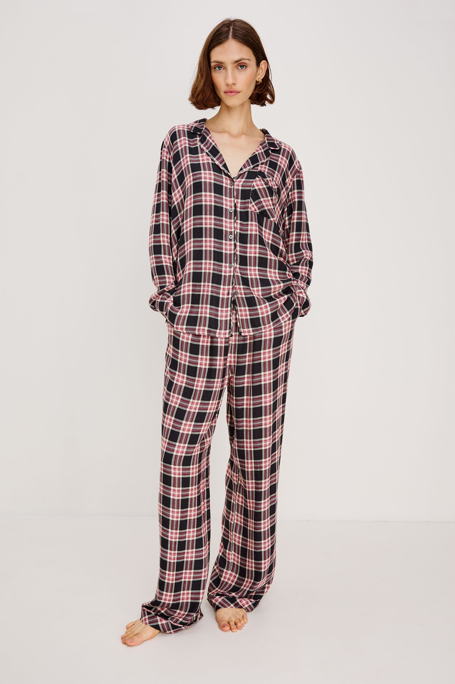 Luna Pajama Set in Signature Rayon With Button-Up Collared Shirt With Front Buttons, Long Sleeves, Chest Patch Pocket and Matching Pant With Side Pockets and Drawstring Waist Ties in Onyx Plum Plaid Colorway - Full Body Front View Featured on Model