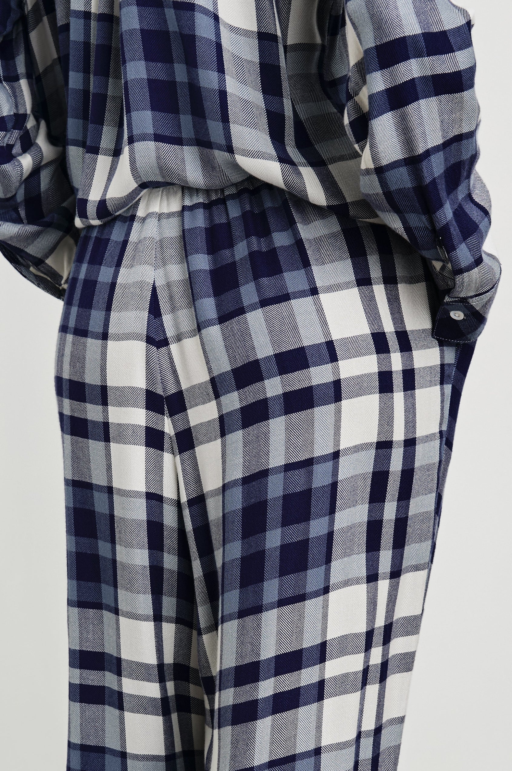 Luna Pajama Set with a Long Sleeve, Button Up, V Neck Top with a Chest Patch Pocket and Pants with Two Front Pockets in Lake Blue Cloud Colorway, a plaid - Back View Featured on Model  