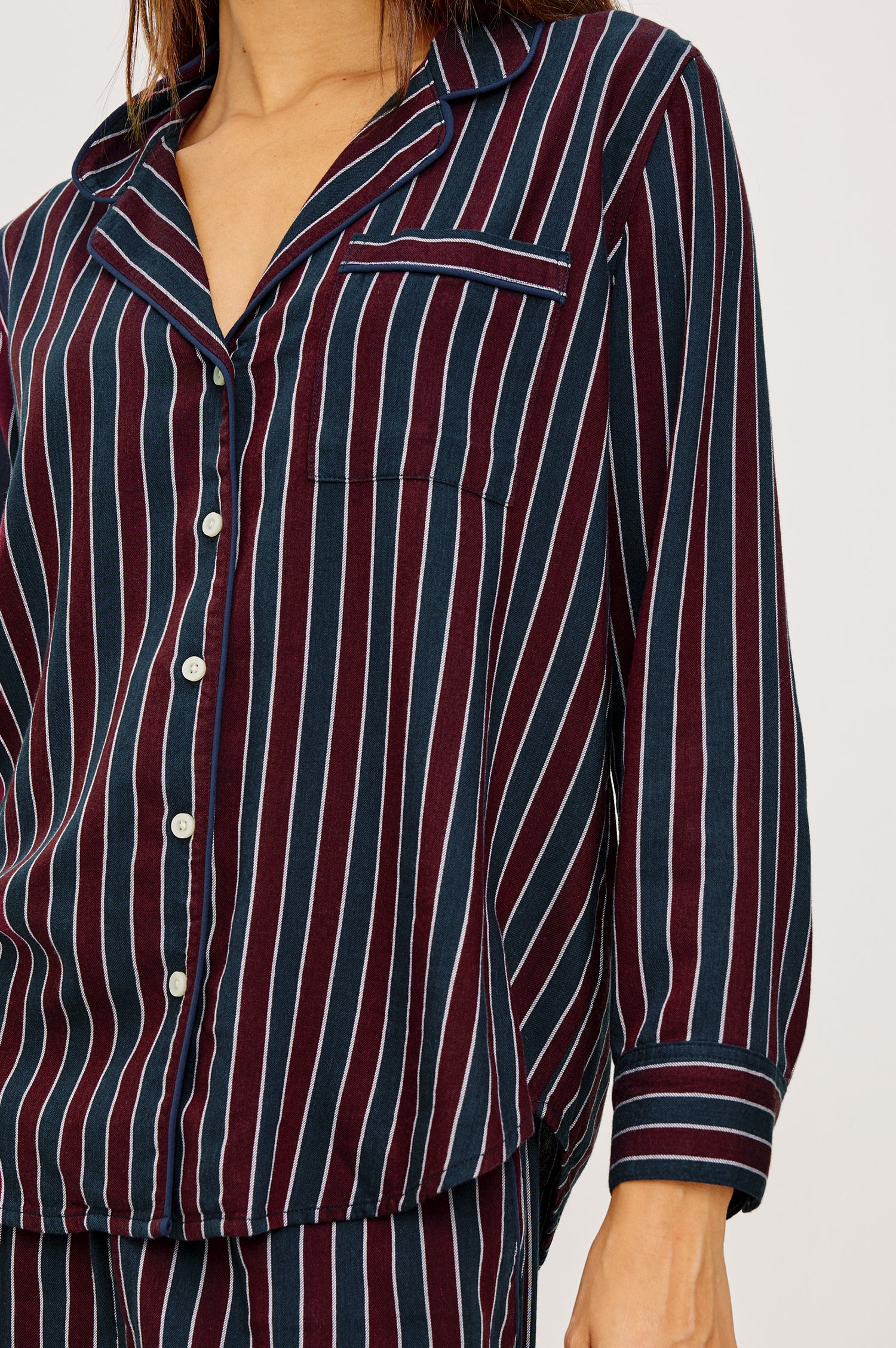 Luna Pajama Set in Signature Rayon With Button-Up Collared Shirt With Front Buttons, Long Sleeves, Chest Patch Pocket and Matching Pant With Side Pockets and Drawstring Waist Ties in Navy Oxblood Stripe Colorway - Upper Body Close Up Front View Featured on Model