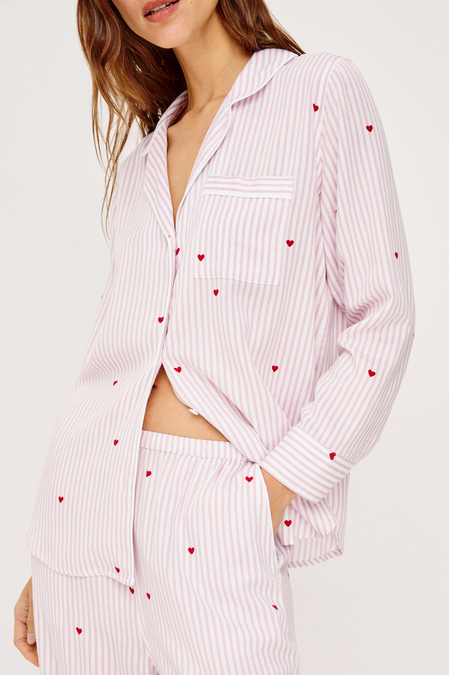 Luna Pajama Set in Signature Rayon With Button-Up Collared Shirt With Front Buttons, Long Sleeves, Chest Patch Pocket and Matching Pant With Side Pockets and Drawstring Waist Ties in Rose Stripe Hearts Colorway - Upper Body Close Up View Featured on Model