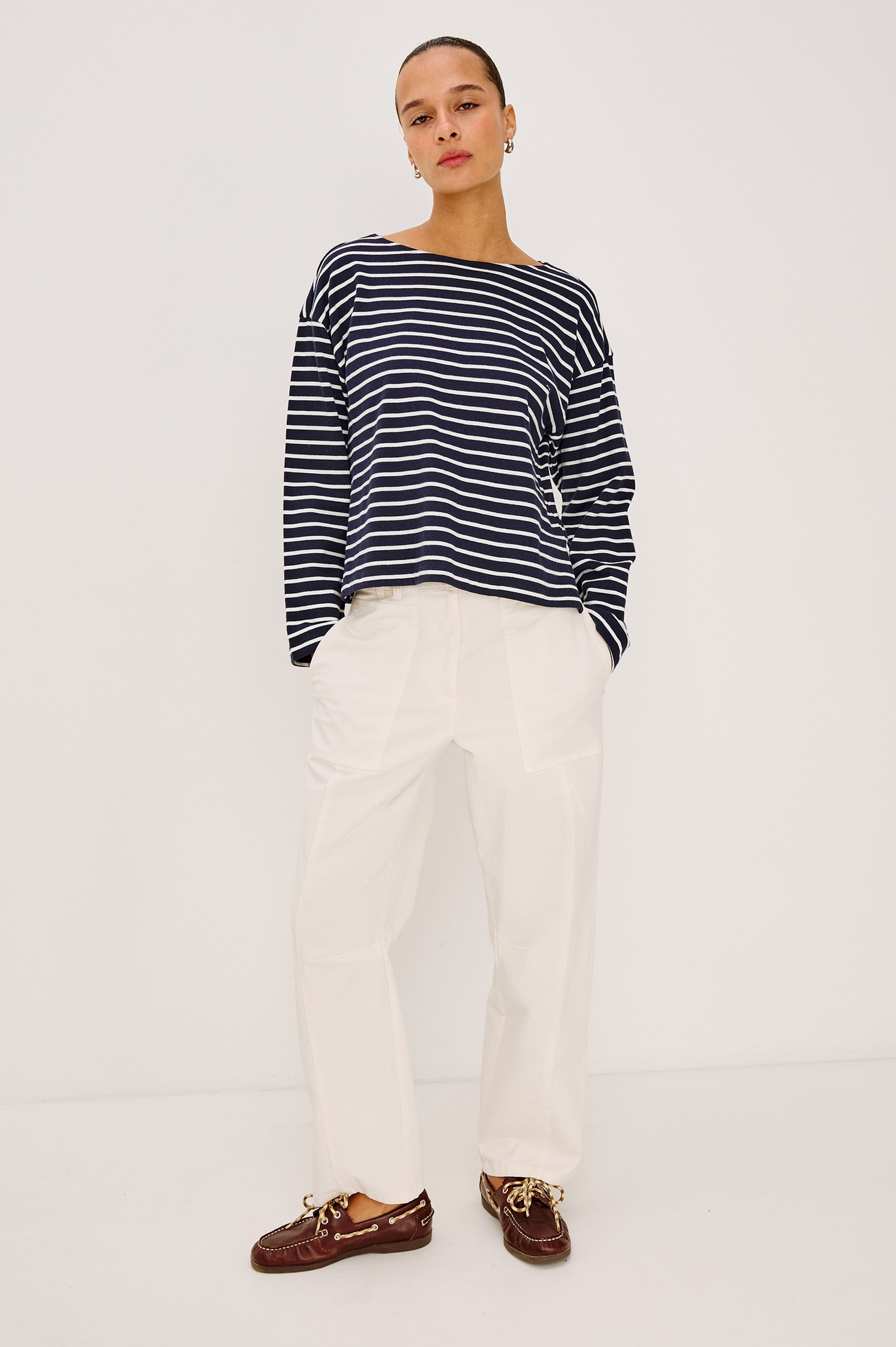 Lunar Pant in Stretch Corduroy With Relaxed Straight Legs, Zip-Fly Closure, Belt Loops, Seam Detailing, Carpenter-Style Side Pockets, and Back Pockets in Bone Colorway - Full Body Front View Featured on Model