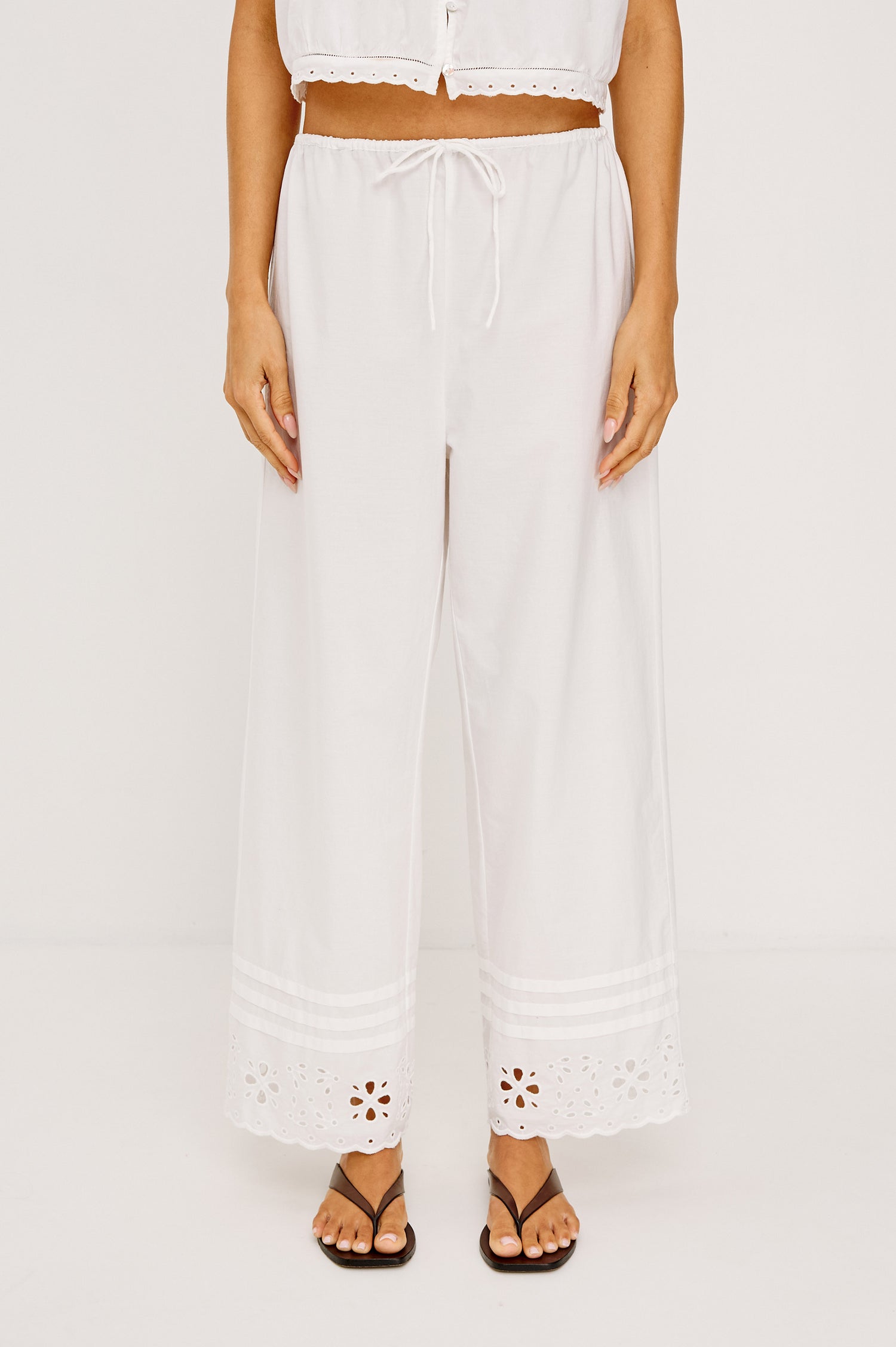 Lydia Mid-Rise Straight Leg Pant in Cotton Poplin With Adjustable Drawcords, and Eyelet Embroidery in White Colorway - Lower Body Front View Featured on Model