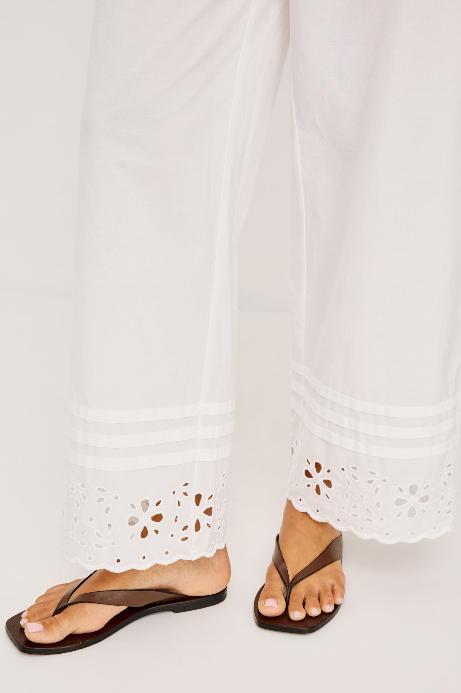 Lydia Mid-Rise Straight Leg Pant in Cotton Poplin With Adjustable Drawcords, and Eyelet Embroidery in White Colorway - Lower Body Front View Featured on Model