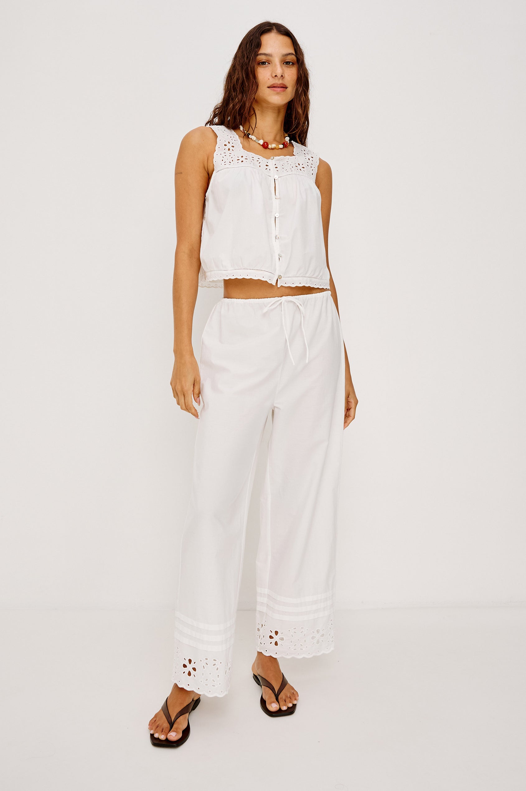 Lydia Mid-Rise Straight Leg Pant in Cotton Poplin With Adjustable Drawcords, and Eyelet Embroidery in White Colorway - Full Body Front View Featured on Model