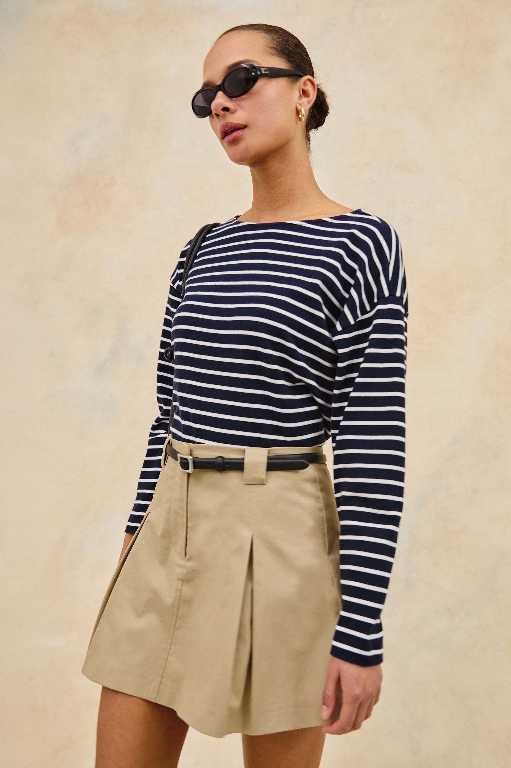 Macy long sleeve shirt with boat neckline and flared long sleeve in Nautical Stripe - stylized front view on model with purse and sunglasses, slight angle