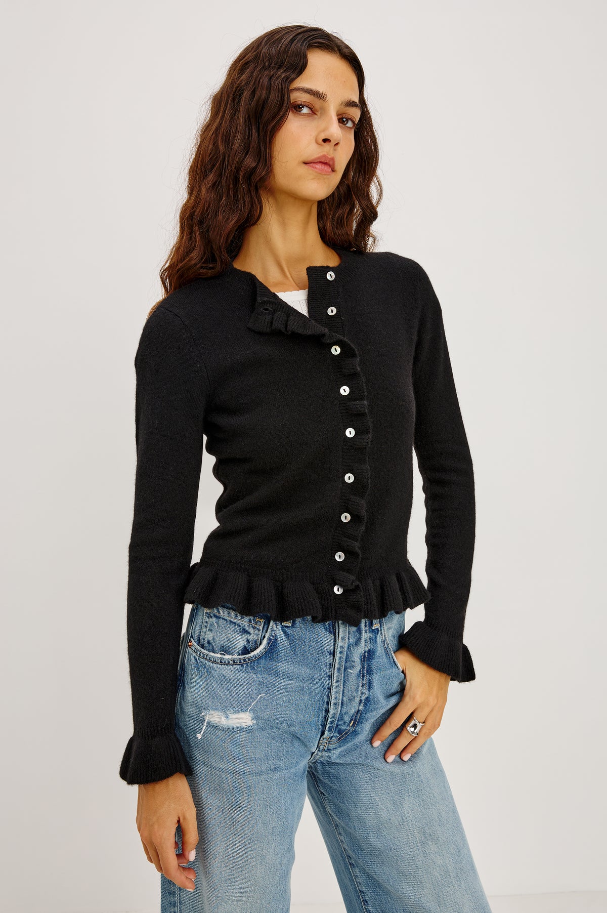 Mandy Sweater in Cashmere-Cotton-Wool Blend Knit Front Buttons, Long Sleeves, Classic Slightly Cropped Fit, and Ribbed Ruffle Trim in Black Colorway - Front Crop View Featured on Model.
