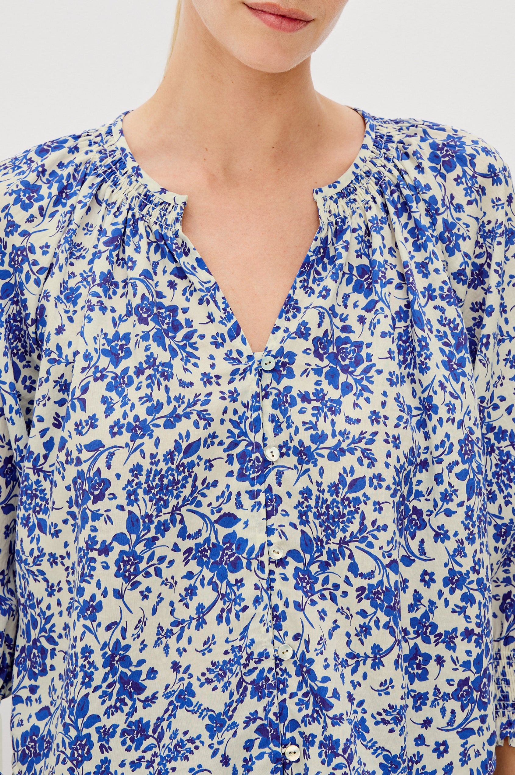 Mariah Button Down Shirt With 3/4" Length Sleeves with Elastic Smoking at Sleeve Hem, V-Neck and Half Button Front in Blue Marguerite Colorway - Front Detail View Featured on Model.