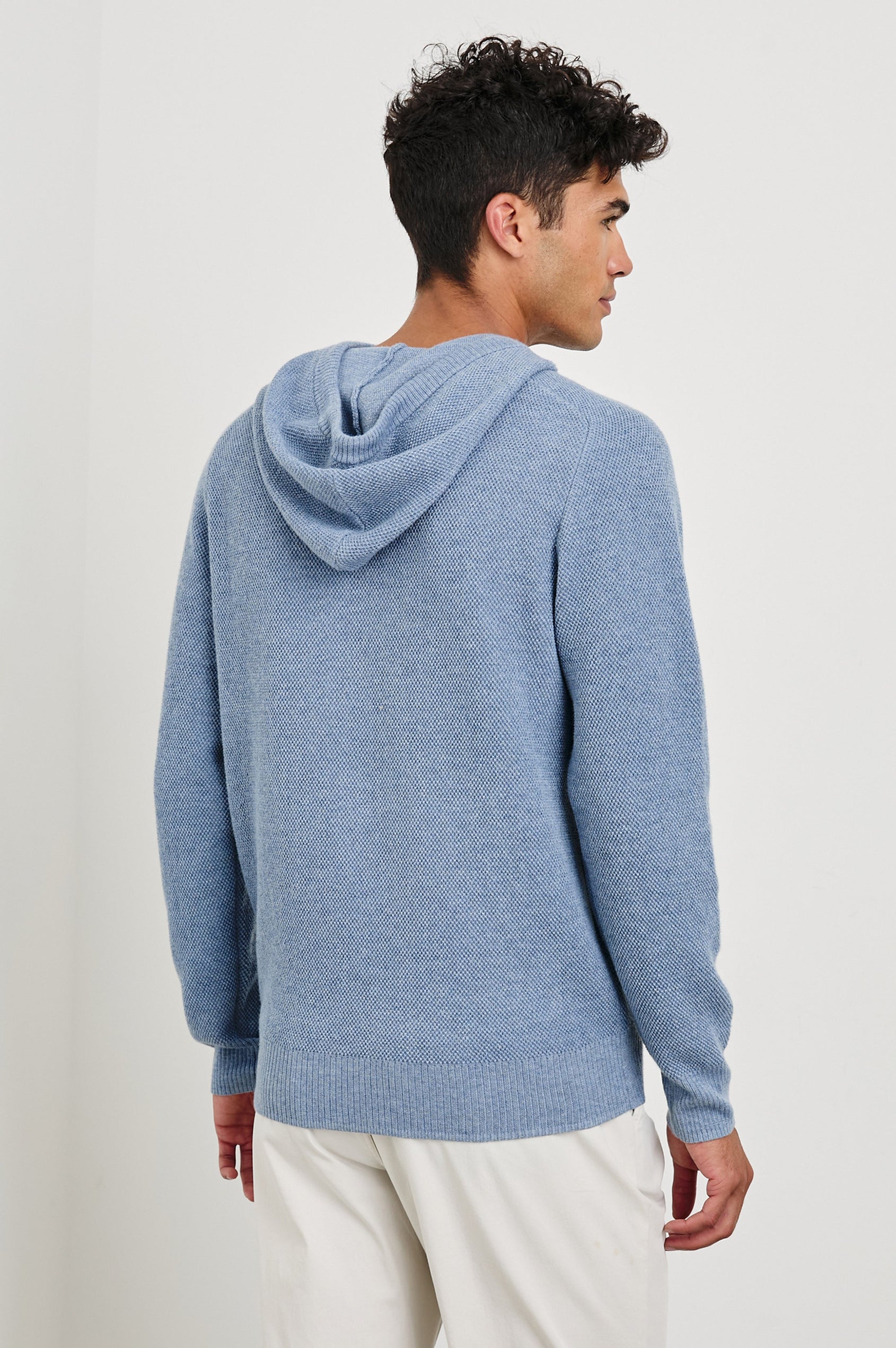 Matador knit sweater with hoodie, adjustable drawstrings, and dual side front pocket in Light Blue Heather -back view on model