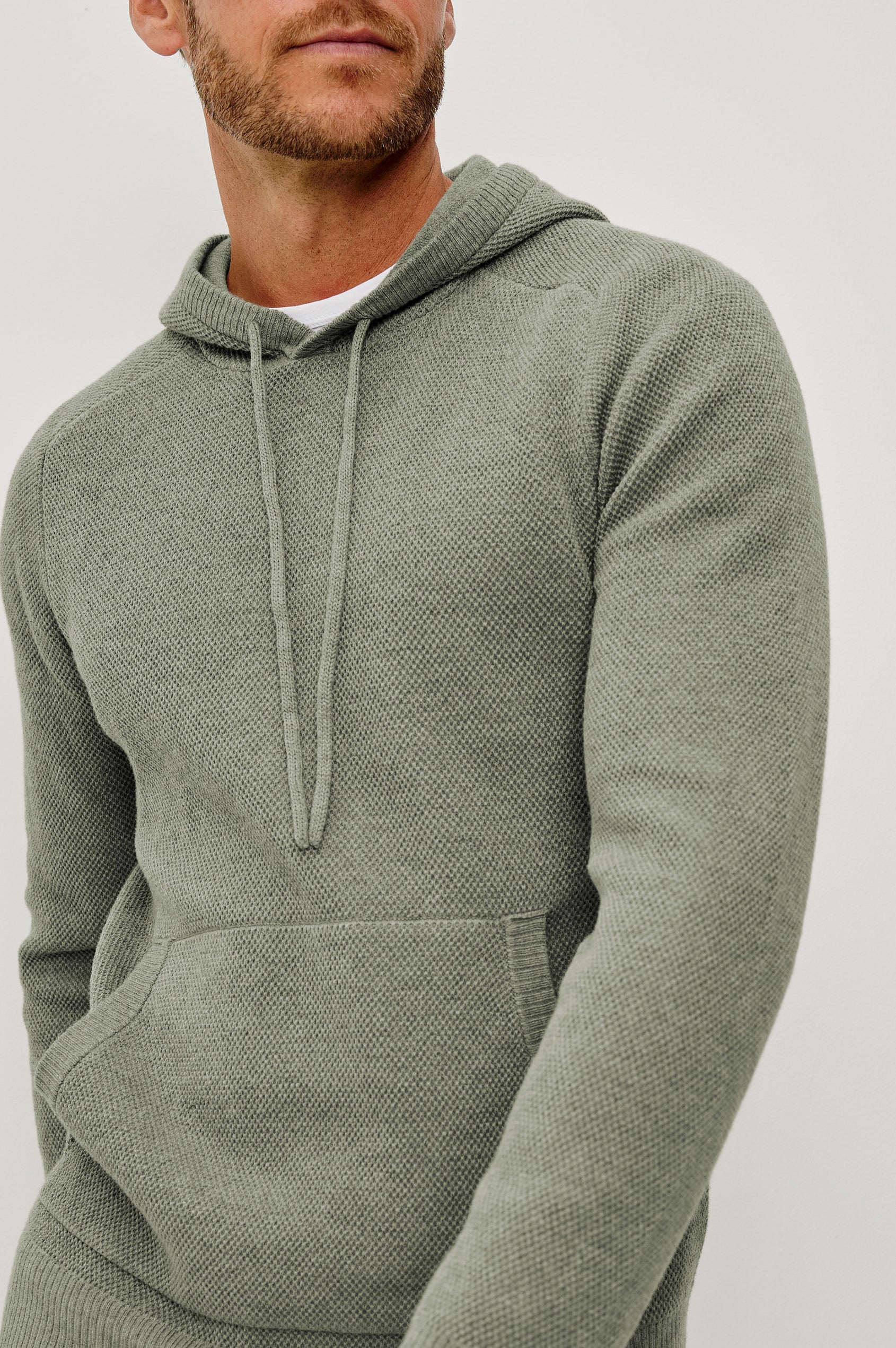 Matador Hoodie Sweatshirt in Cotton Blend With Drawstring TIes, Front Kangaroo Pockets, and Long Sleeves in Sage Heather - Upper Body Close Up Front View Featured on Model