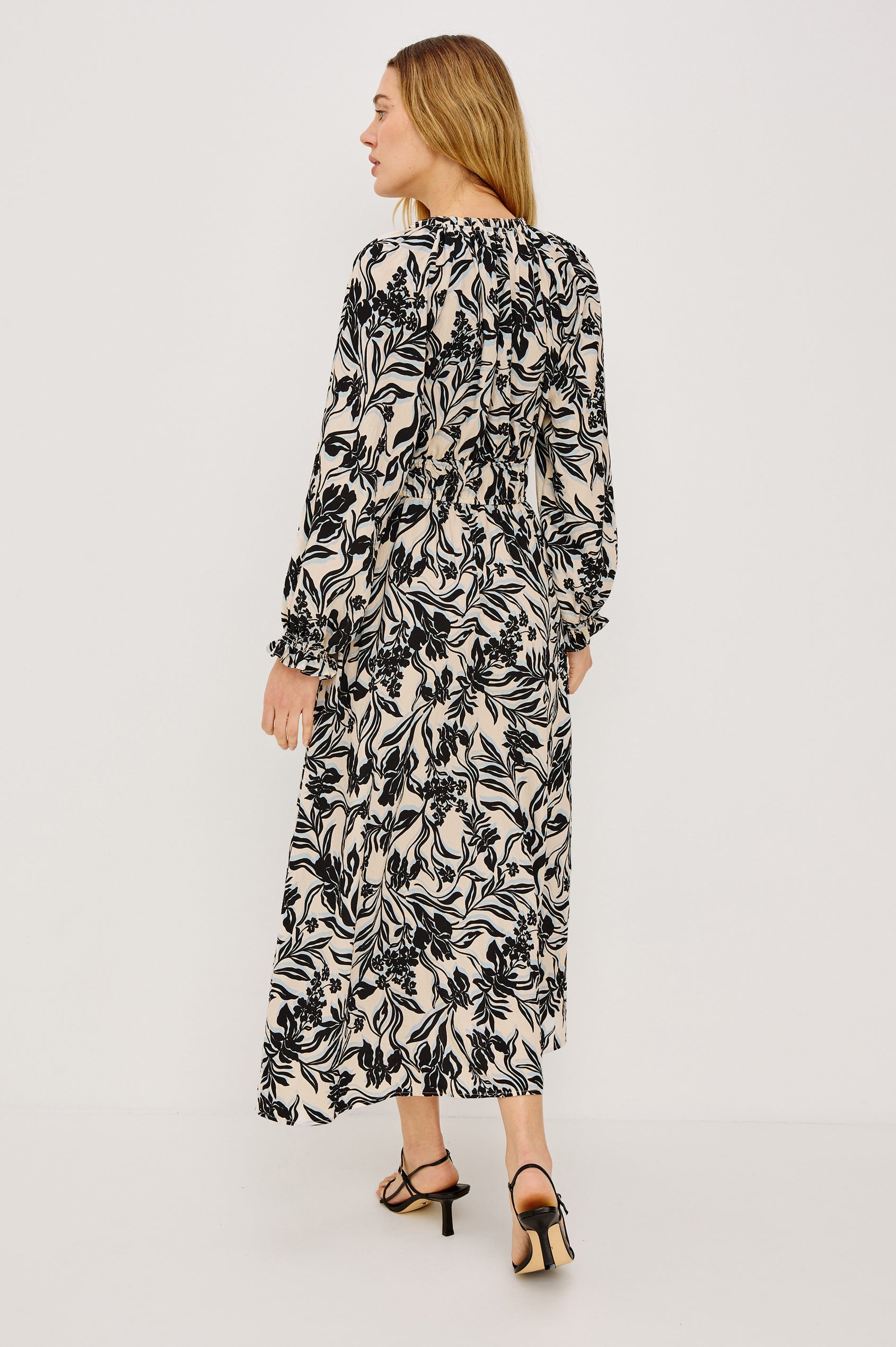 Matia Maxi Dress in Cotton With Banded Ruffle V-Neckline With Self-Ties, Elastic Waist, and Long Raglan Puff Sleeves in Zinya Colorway - Full Body Back View Featured on Model