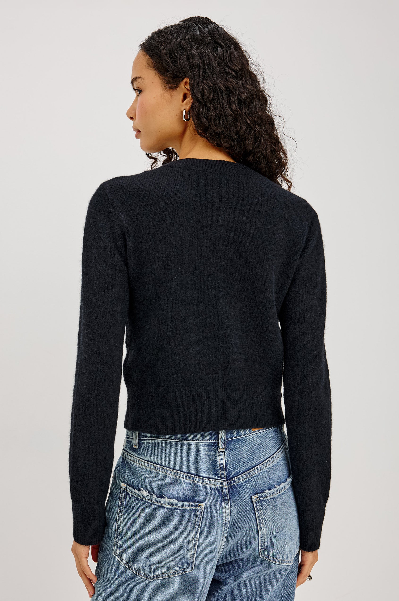 Matilda Cardigan in Wool-Blend Knit WIth Relaxed Slightly Cropped Fit, Crew Neck, Front Buttons, and Ribbed Trim in Black Colorway - Upper Body Back View Featured on Model