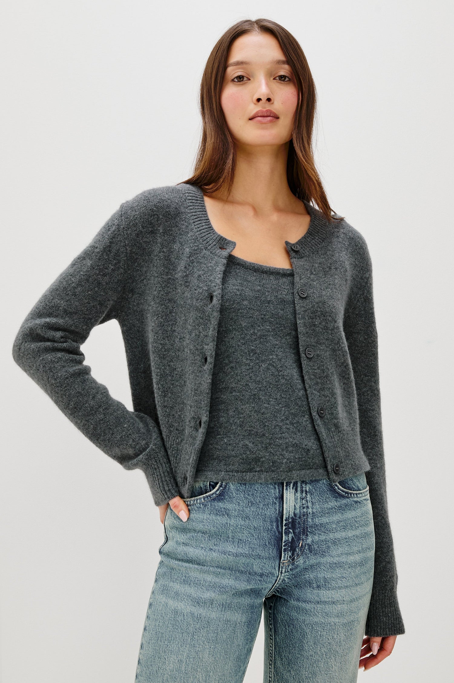 Matilda Cropped Long-Sleeve Sweater with Button Closure, Crew Neck and Ribbed Trim in Charcoal Colorway - Front View Featured on Model, layered over matching tank
