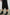 Maya Midi Skirt with Mid-Thigh Side Slit in Black Colorway - Side View Featured on Model