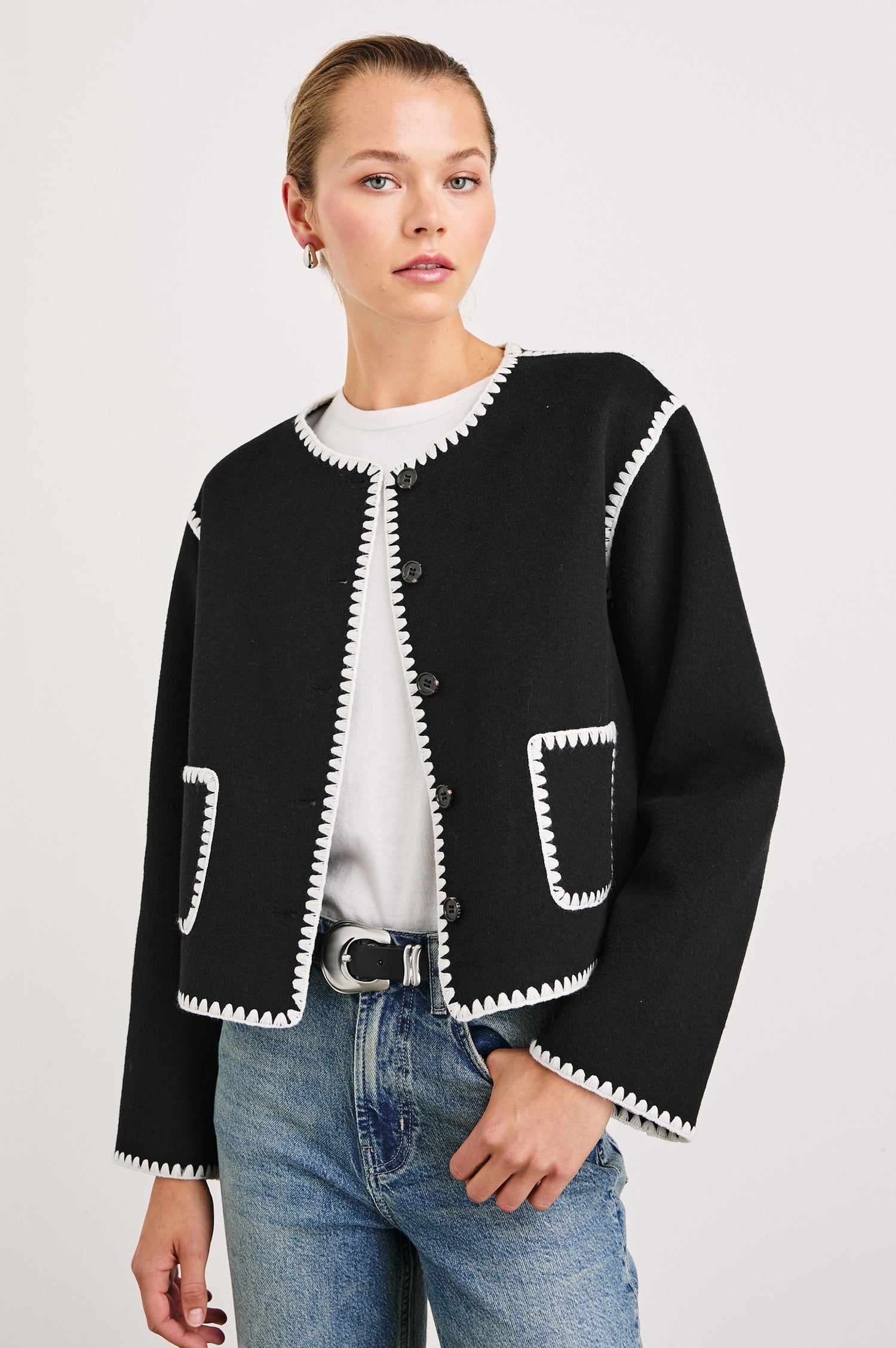 Melanie Jacket with Button Closure and Two Front Patch Pockets in Black Colorway, with White Stitching along the Trim and Pockets - Front View Featured on Model