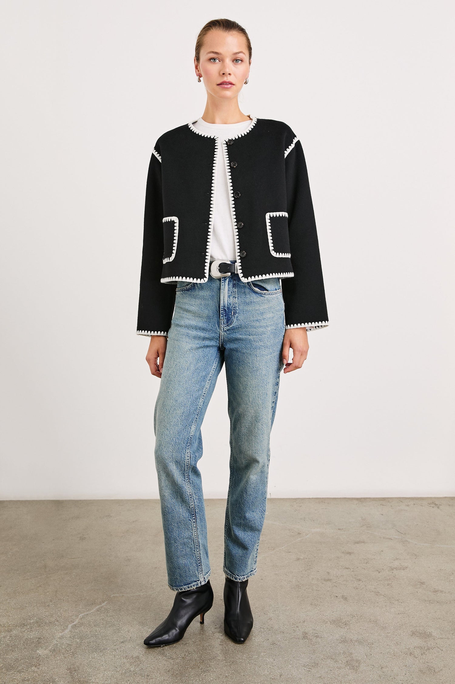 Melanie Jacket with Button Closure and Two Front Patch Pockets in Black Colorway, with White Stitching along the Trim and Pockets - Front Full Body View Featured on Model