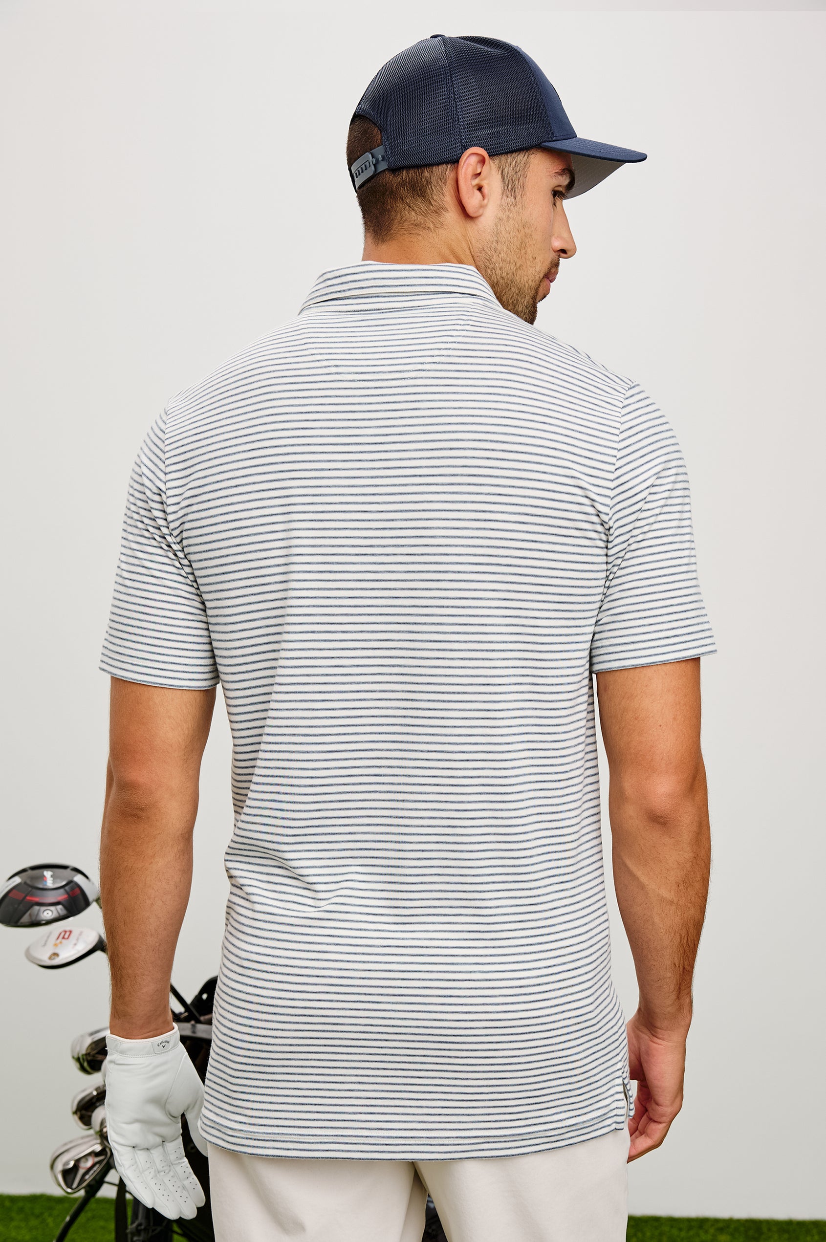 Merced Golf Polo in TENCEL™ Poly Blend With Collar, Quarter Placket, Short Sleeves, and Classic Fit in White Cosmos Stripe Colorway - Upper Body Back View Featured on Model