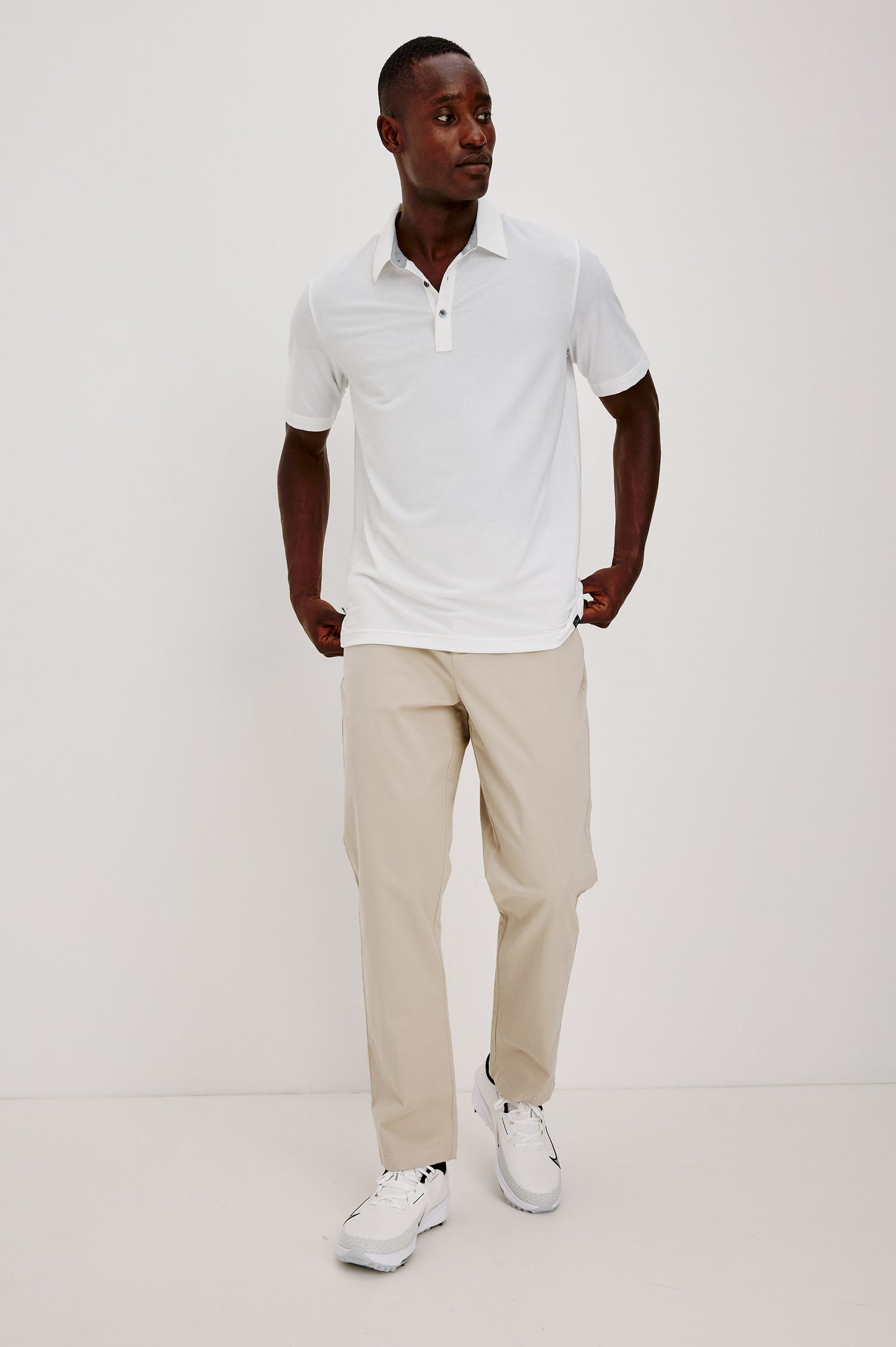 Merced Golf Polo in TENCEL™-Poly Stretch Blend With Moisture-Wicking Properties, Collar, Quarter-Placket, and Short Sleeves in White Colorway - Full Body Front View Featured on Model