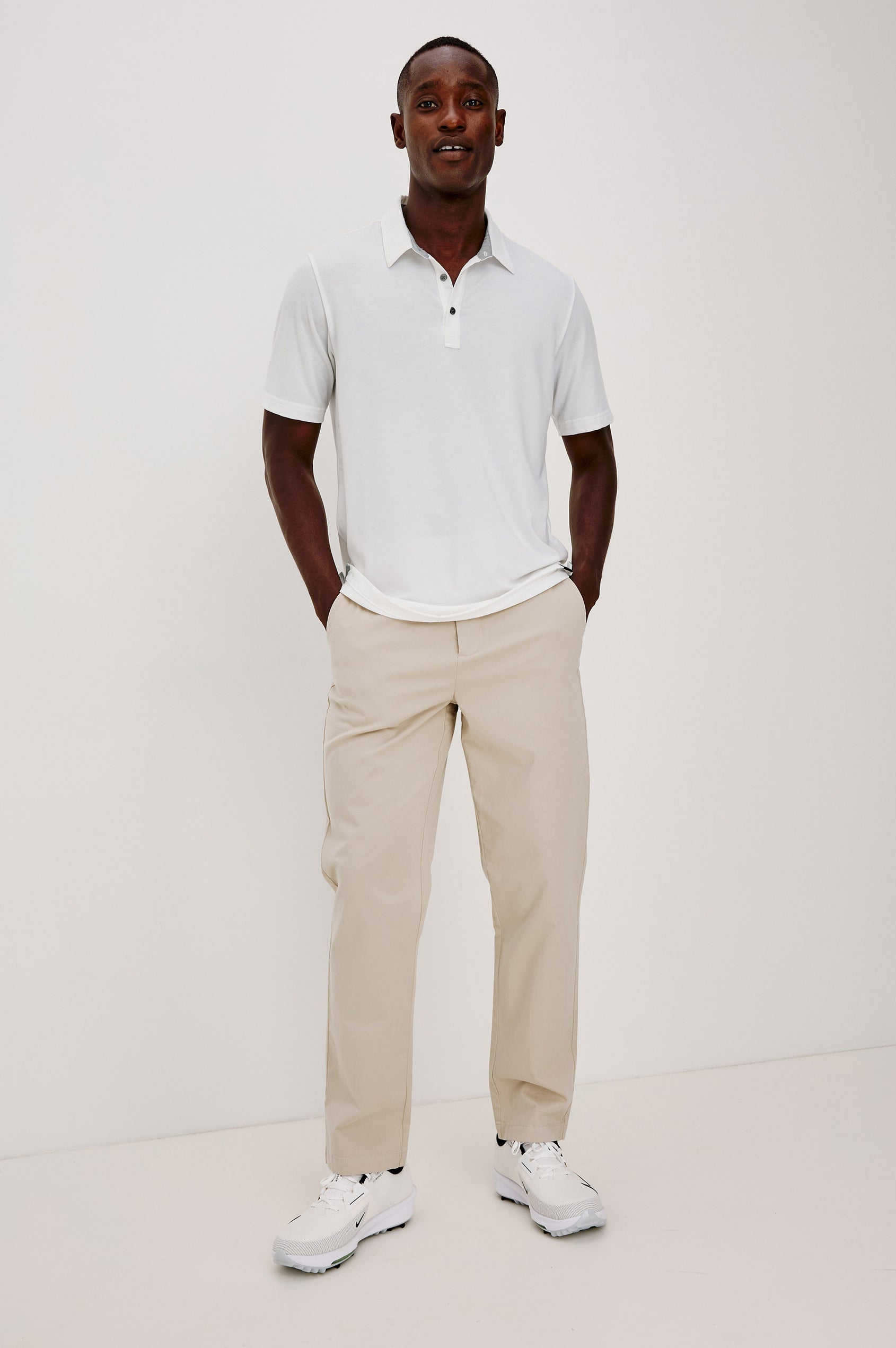 Merced Golf Polo in TENCEL™-Poly Stretch Blend With Moisture-Wicking Properties, Collar, Quarter-Placket, and Short Sleeves in White Colorway - Full Body Front View Featured on Model