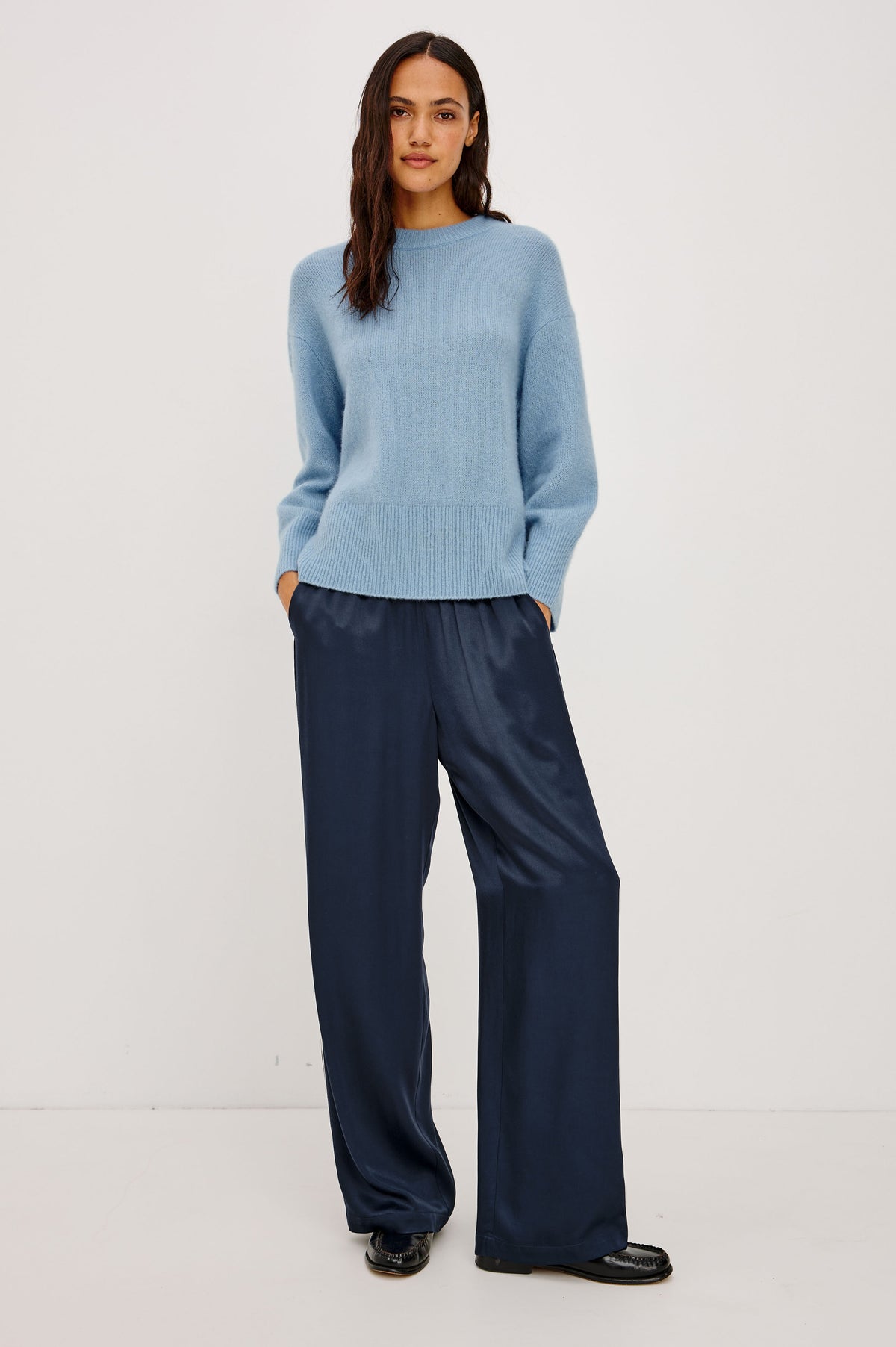 Merida Track Pant in Satin-Back Crepe With Elastic Waist, Side Slant Pockets, Wide Legs, and Contrast Side Stripes in Navy Colorway - Front Full Body View Featured on Model.